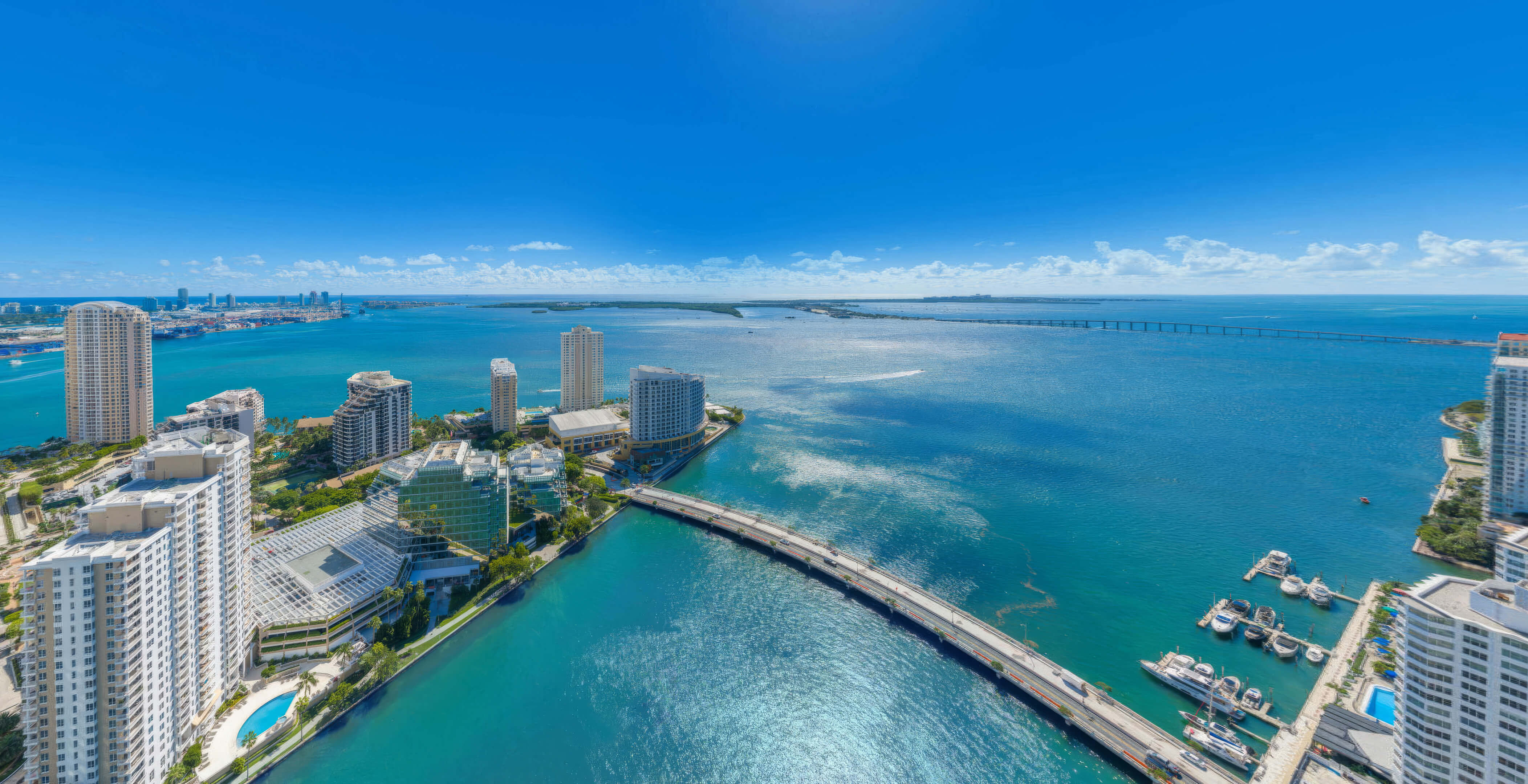 Panoramic Biscayne Bay view from 619 Brickell Residences with bridge, marina, and waterfront skyline