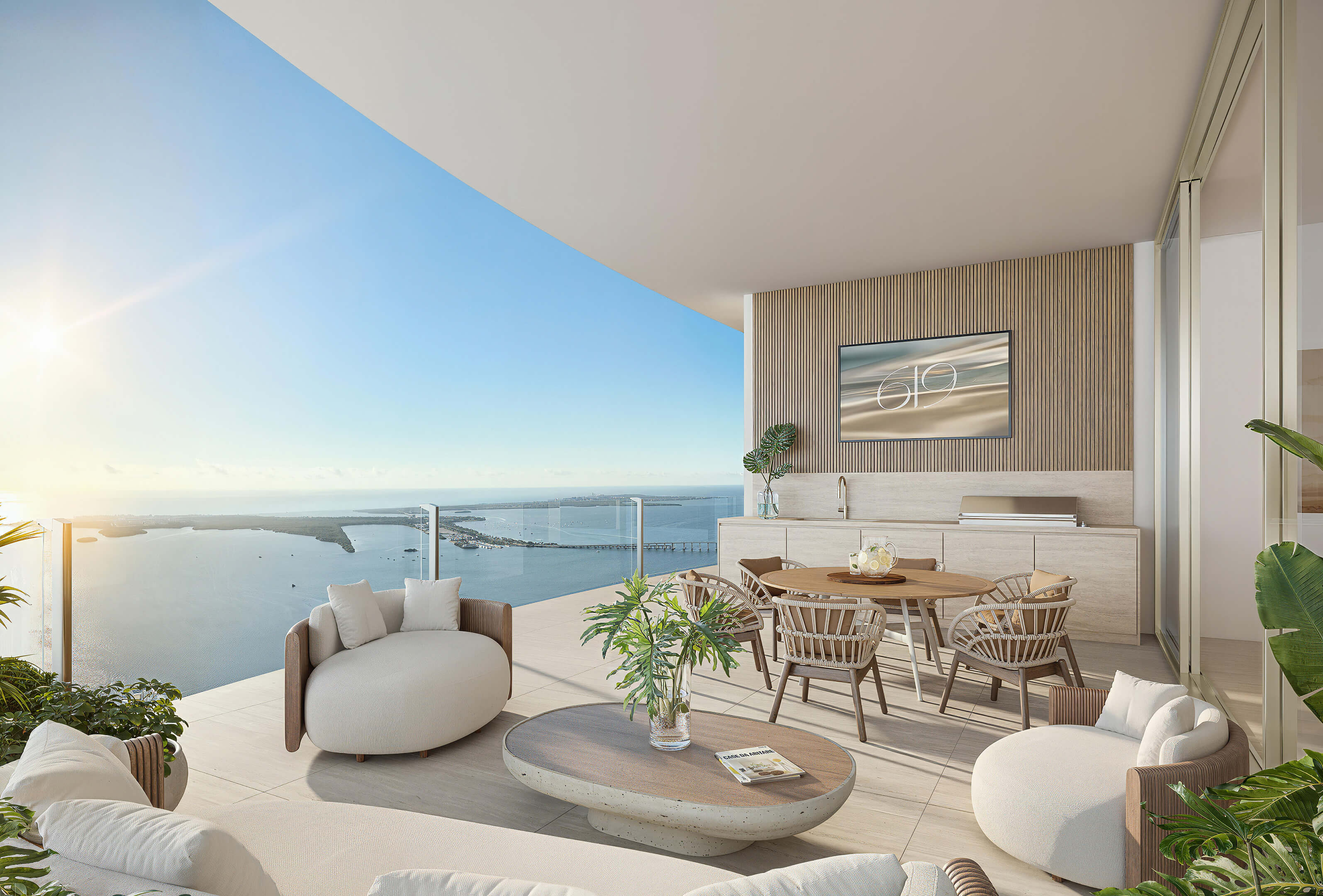 Outdoor terrace dining at 619 Brickell Residences with lounge seating, summer kitchen, and Biscayne Bay views
