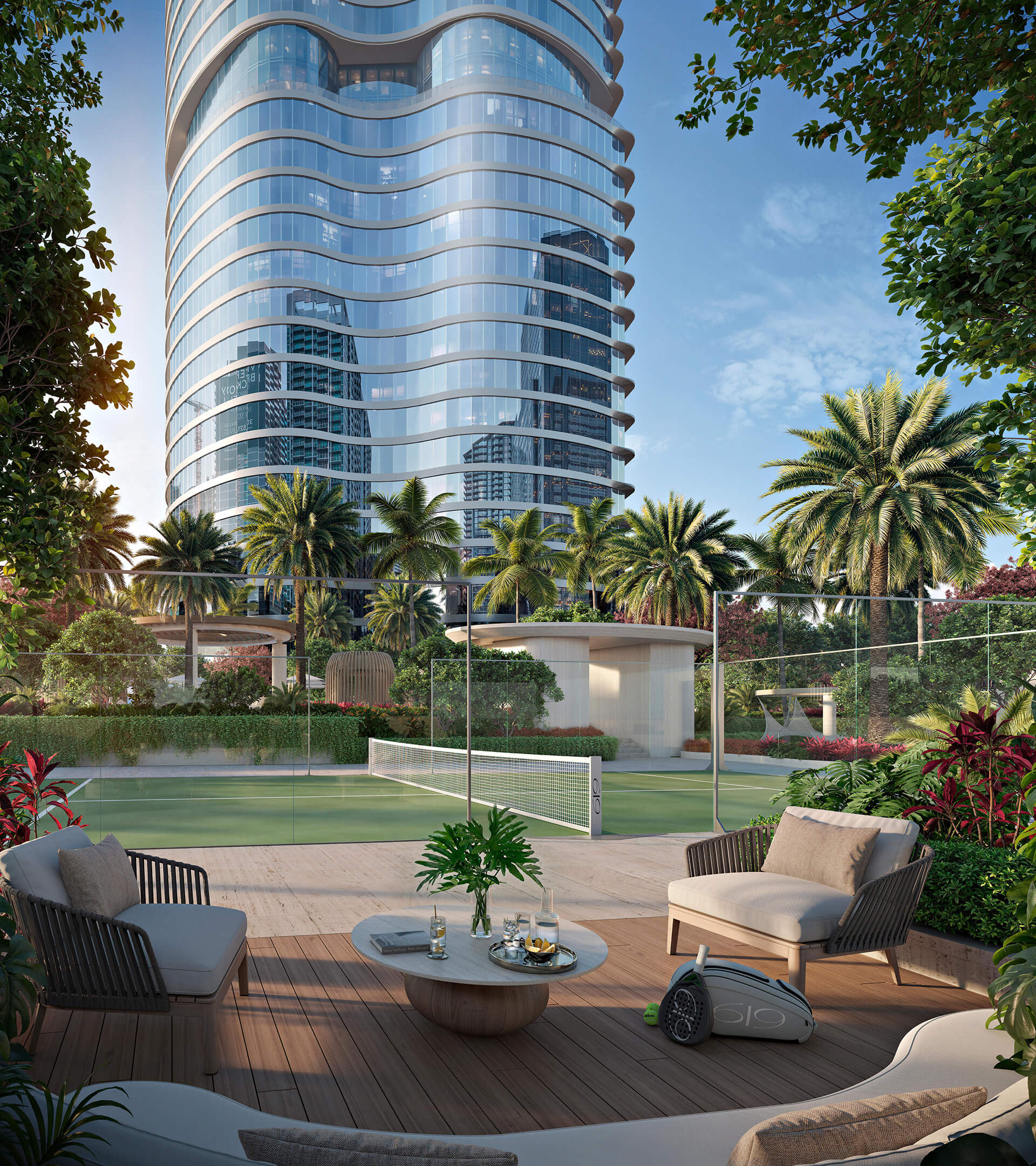 Tennis court at 619 Brickell Residences with tower views, outdoor lounge seating, and tropical landscaping