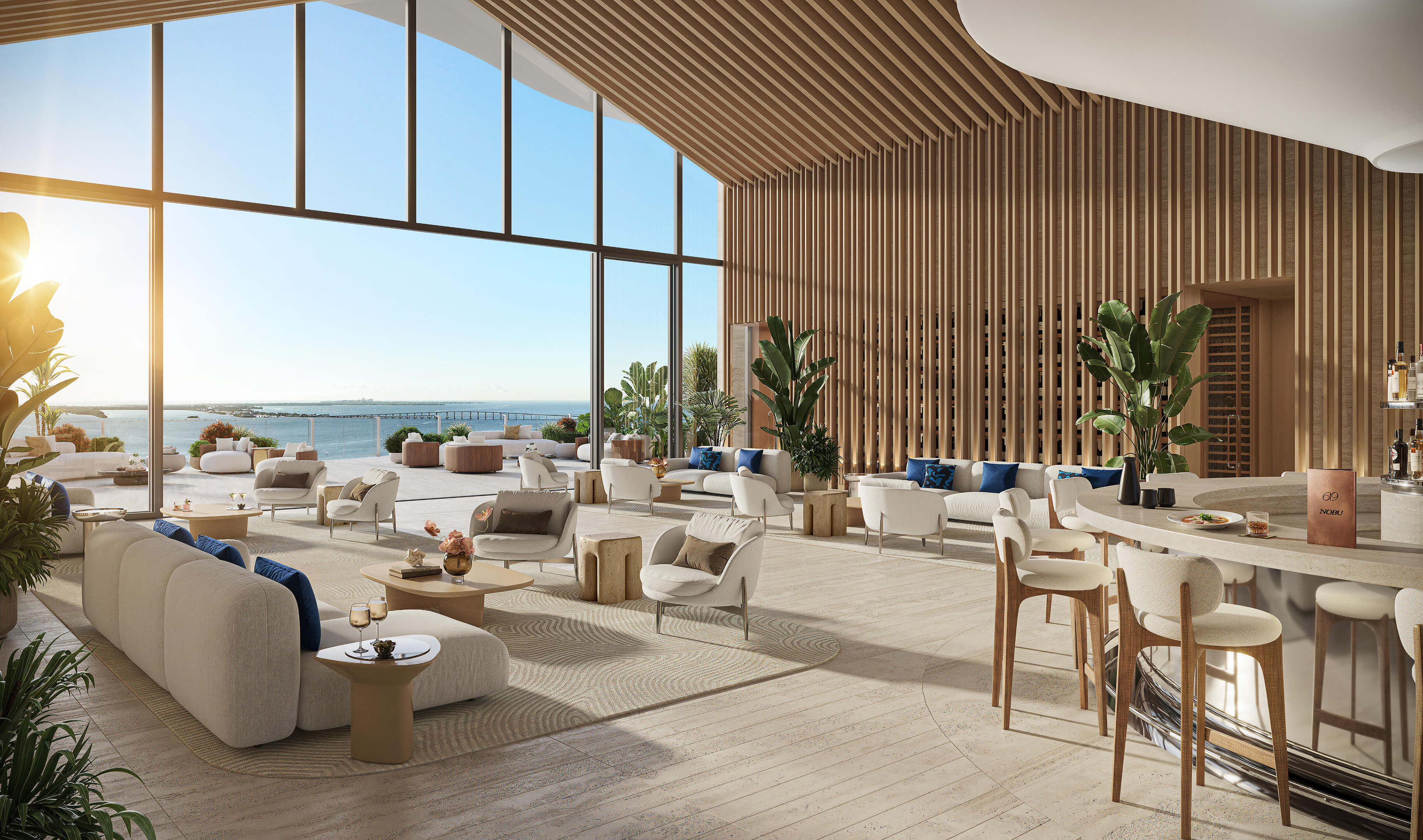 Waterfront amenity lounge at 619 Brickell Residences with floor-to-ceiling windows and refined interiors