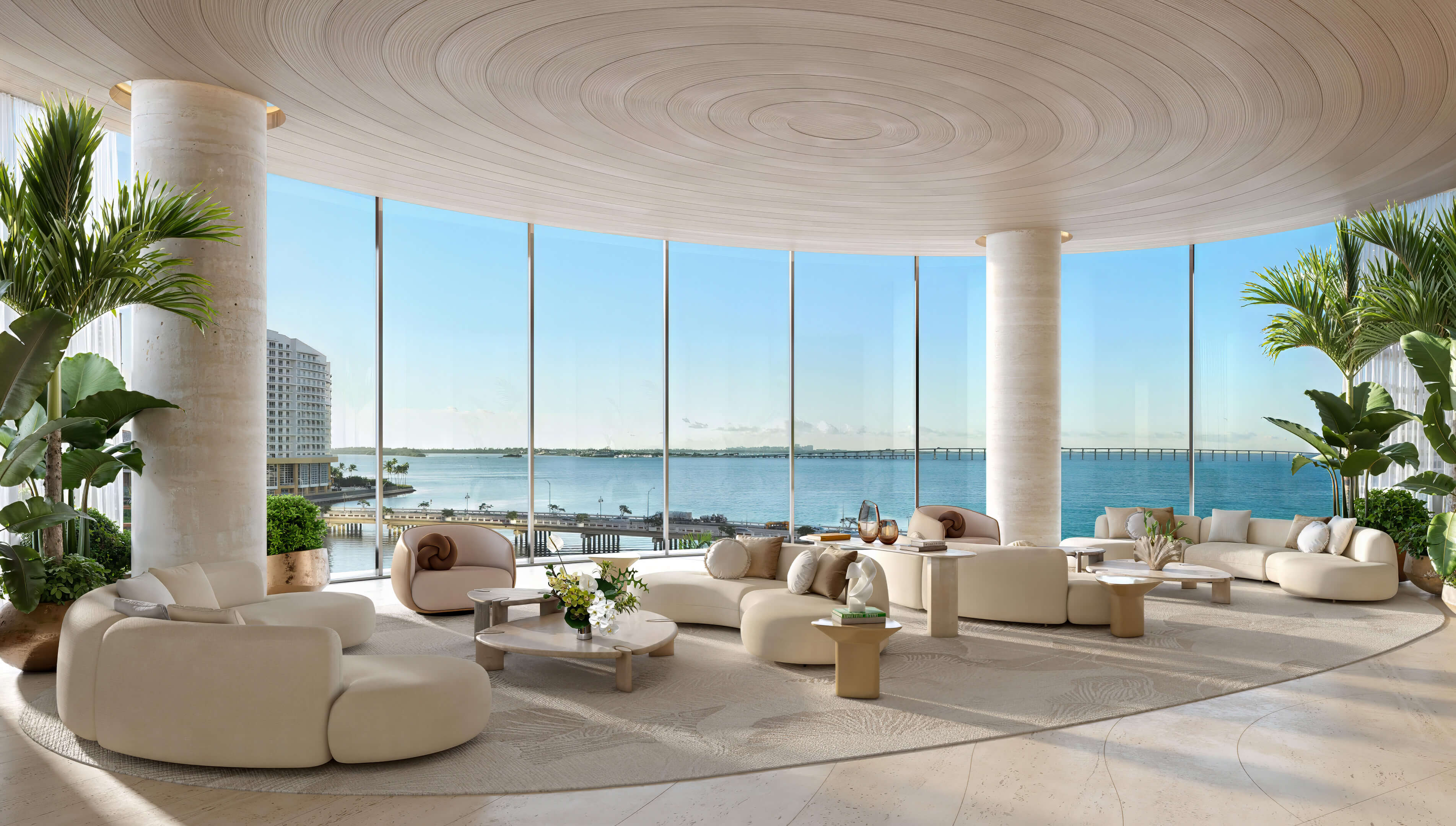 Waterfront resident lounge at 619 Brickell Residences with curved ceiling, tropical plants, and bay views