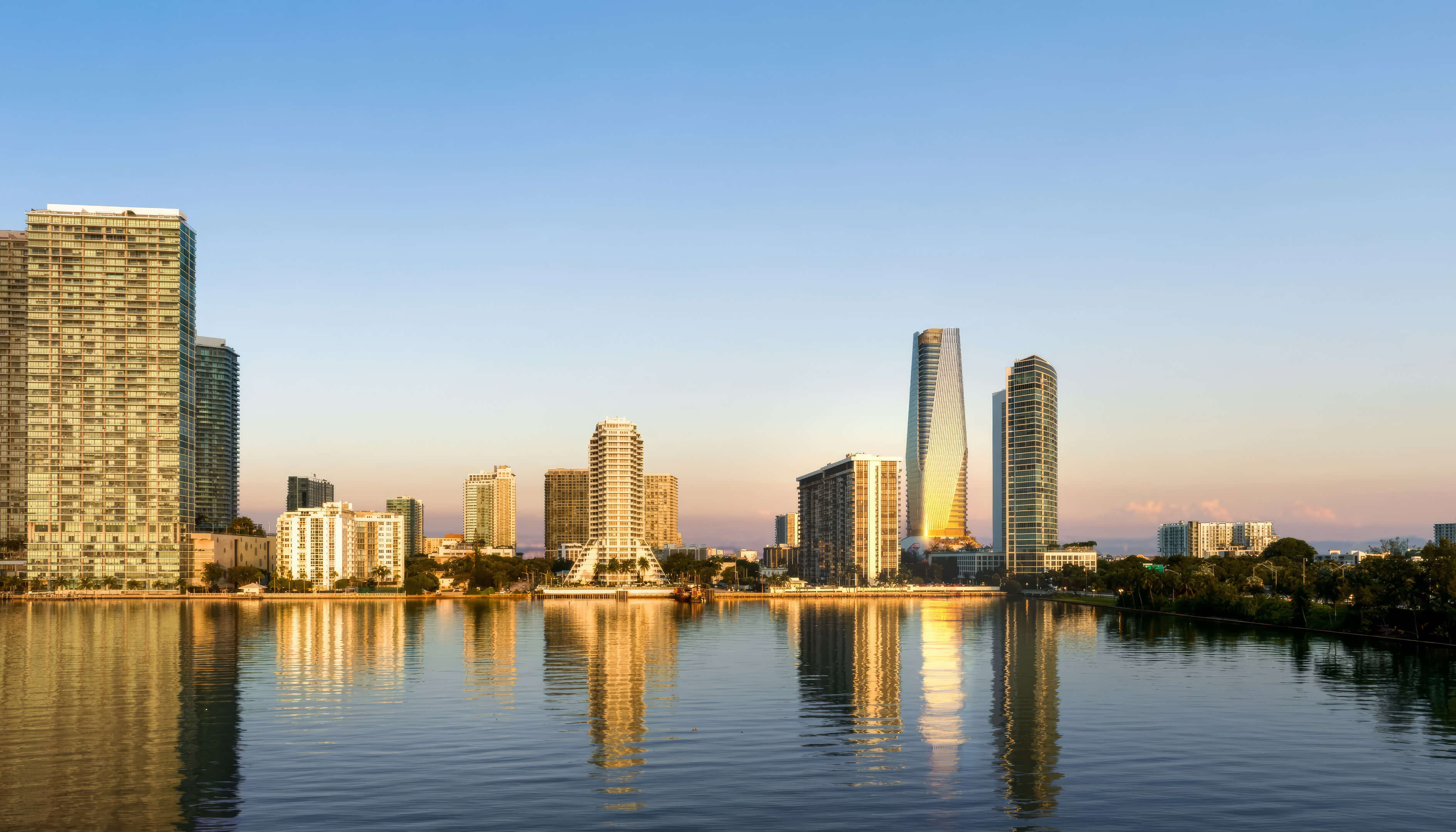 Anantara Resort & Residences Miami skyline waterfront view with luxury tower reflections at sunset