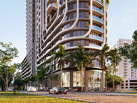 Ground-level corner view of Anatomia Miami Residences featuring retail storefronts, palm trees, and modern curved facade