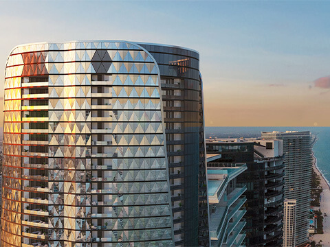 Upper floors of Bentley Residences overlooking the coastline at sunset