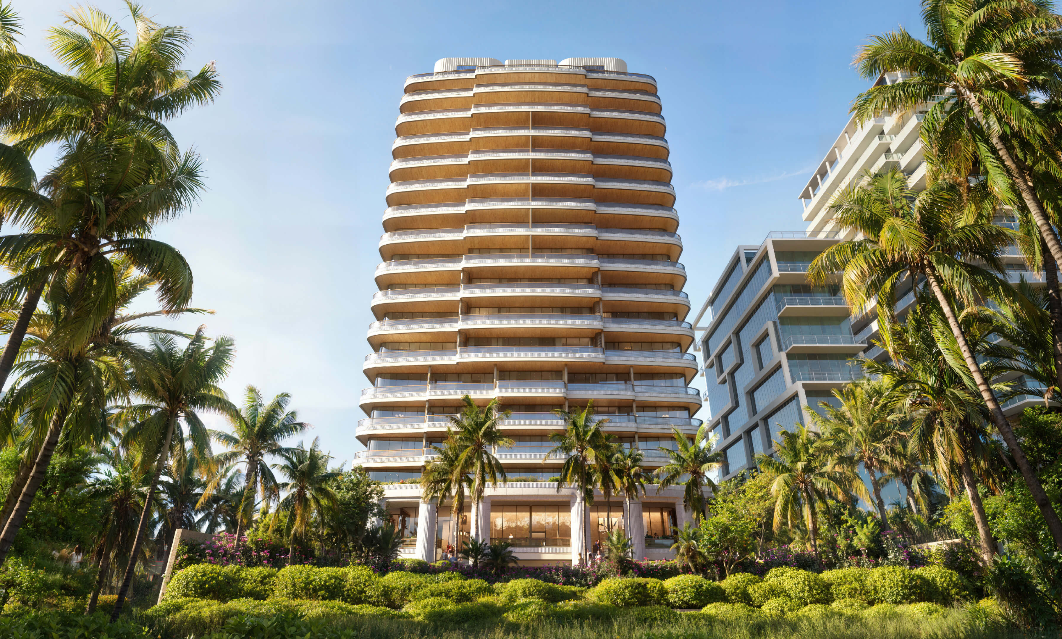 Frontal view of Casa Cipriani Miami Beach showing curved balconies and lush landscaping.