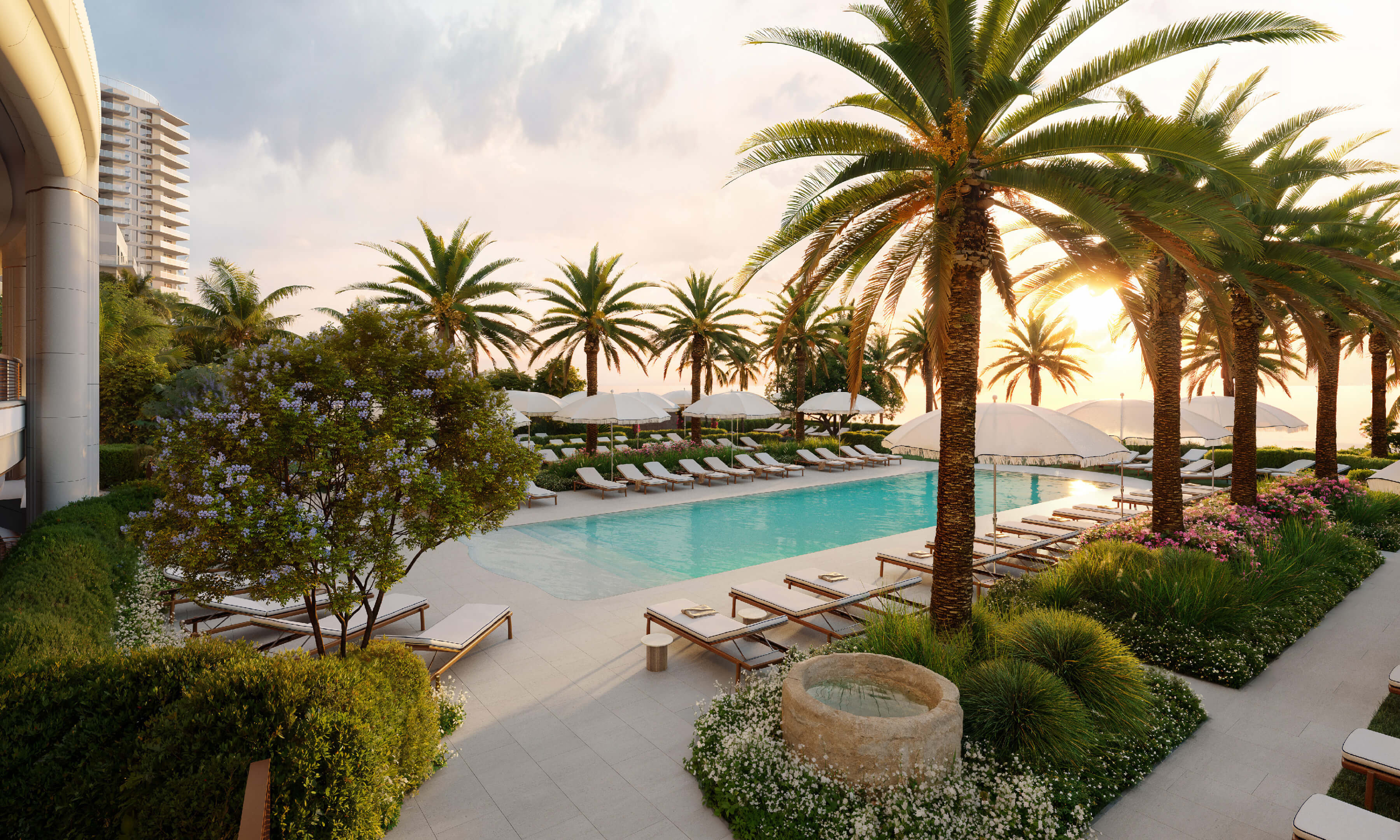 Outdoor pool area of Casa Cipriani Miami Beach with loungers, palm trees, and sunset.