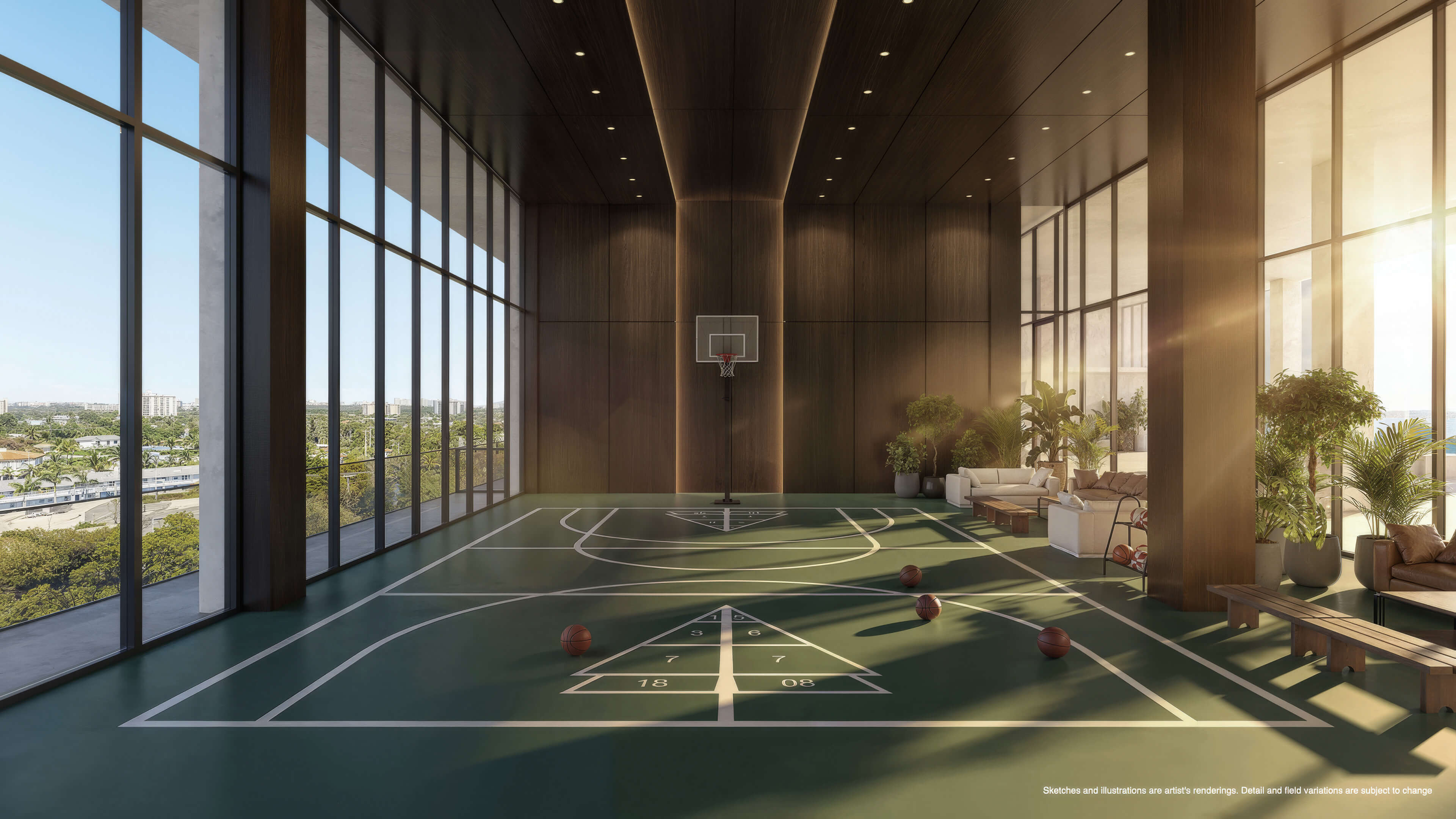 Indoor basketball court at Continuum 12000 North Miami with floor-to-ceiling windows and lounge area