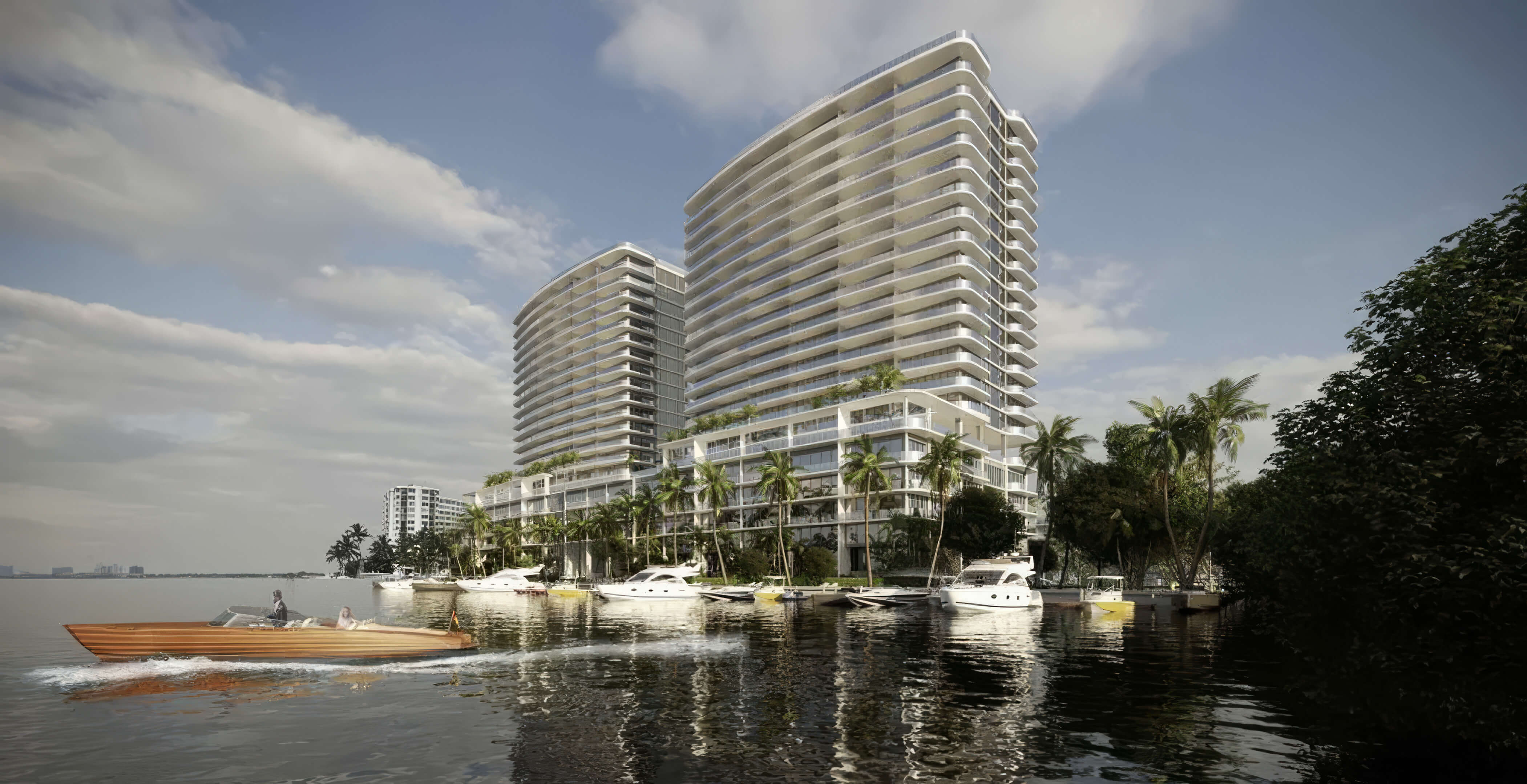 Waterfront towers at Continuum 12000 North Miami with private marina, yachts and contemporary architecture