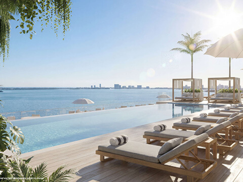 Infinity pool at Continuum 12000 North Miami with luxury loungers and panoramic Biscayne Bay views