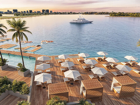 Waterfront sundeck at Continuum 12000 North Miami with cabanas, loungers and marina views