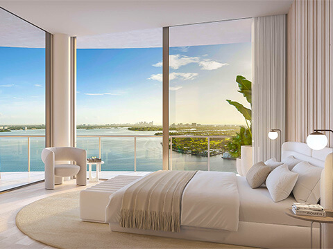 Luxury bedroom at Continuum Club & Residences in North Bay Village with panoramic bay scenery