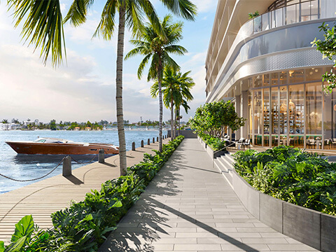 Waterfront promenade and marina access at Continuum Club & Residences surrounded by lush tropical landscaping
