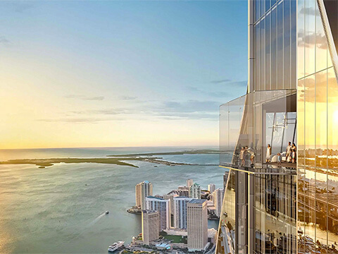Glass balcony perspective at Delano Residences Miami with panoramic bay views at sunset