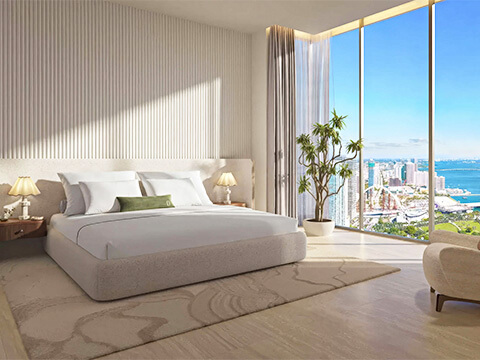 Primary bedroom at Delano Residences Miami with panoramic ocean and bay views through corner windows