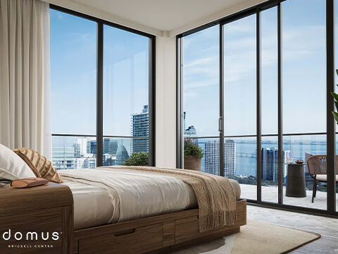 Corner bedroom at Domus Brickell Center featuring panoramic floor-to-ceiling windows and Biscayne Bay views