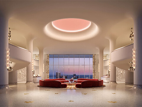 Grand lobby at Faena Residences Miami with sweeping staircases, panoramic window, and modern lounge seating