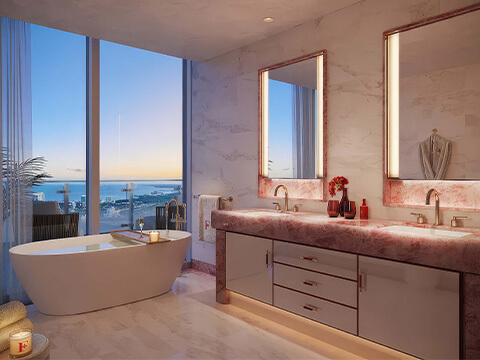 Luxury bathroom at Faena Residences Miami with freestanding soaking tub, double vanity, and bay view