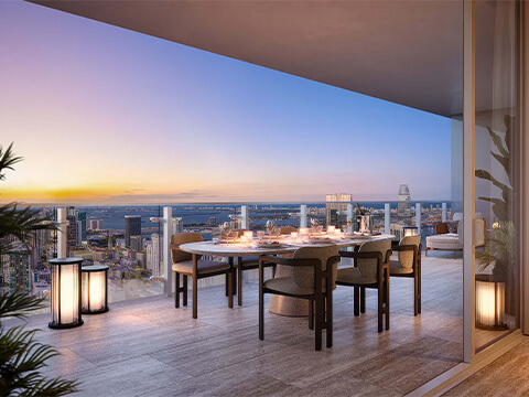 Sunset terrace dining at Faena Residences Miami with skyline views, outdoor table setting, and ambient lighting