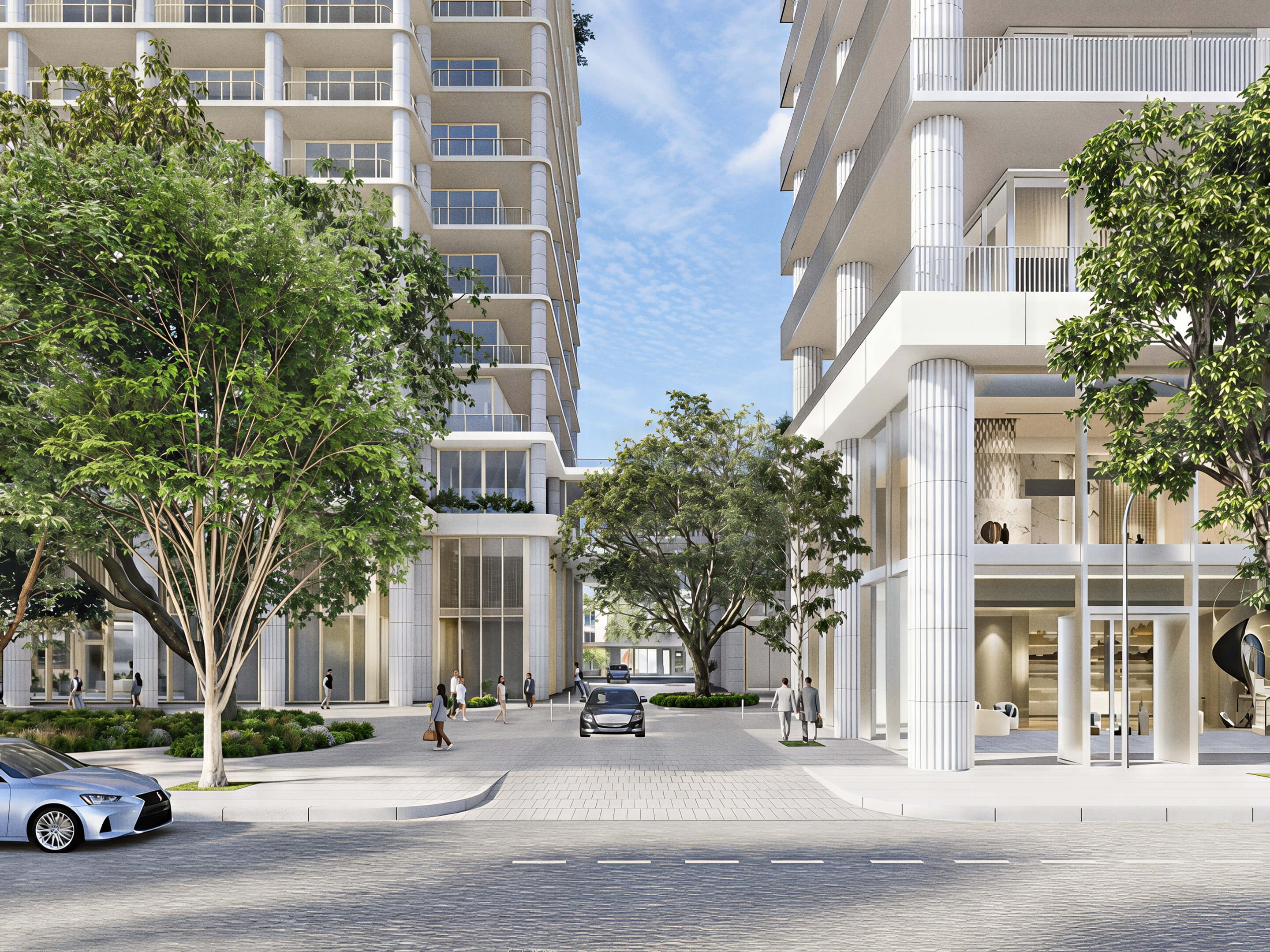 Arrival courtyard between towers with mature trees and tall entrance columns at Fouquet’s Hotel & Residences