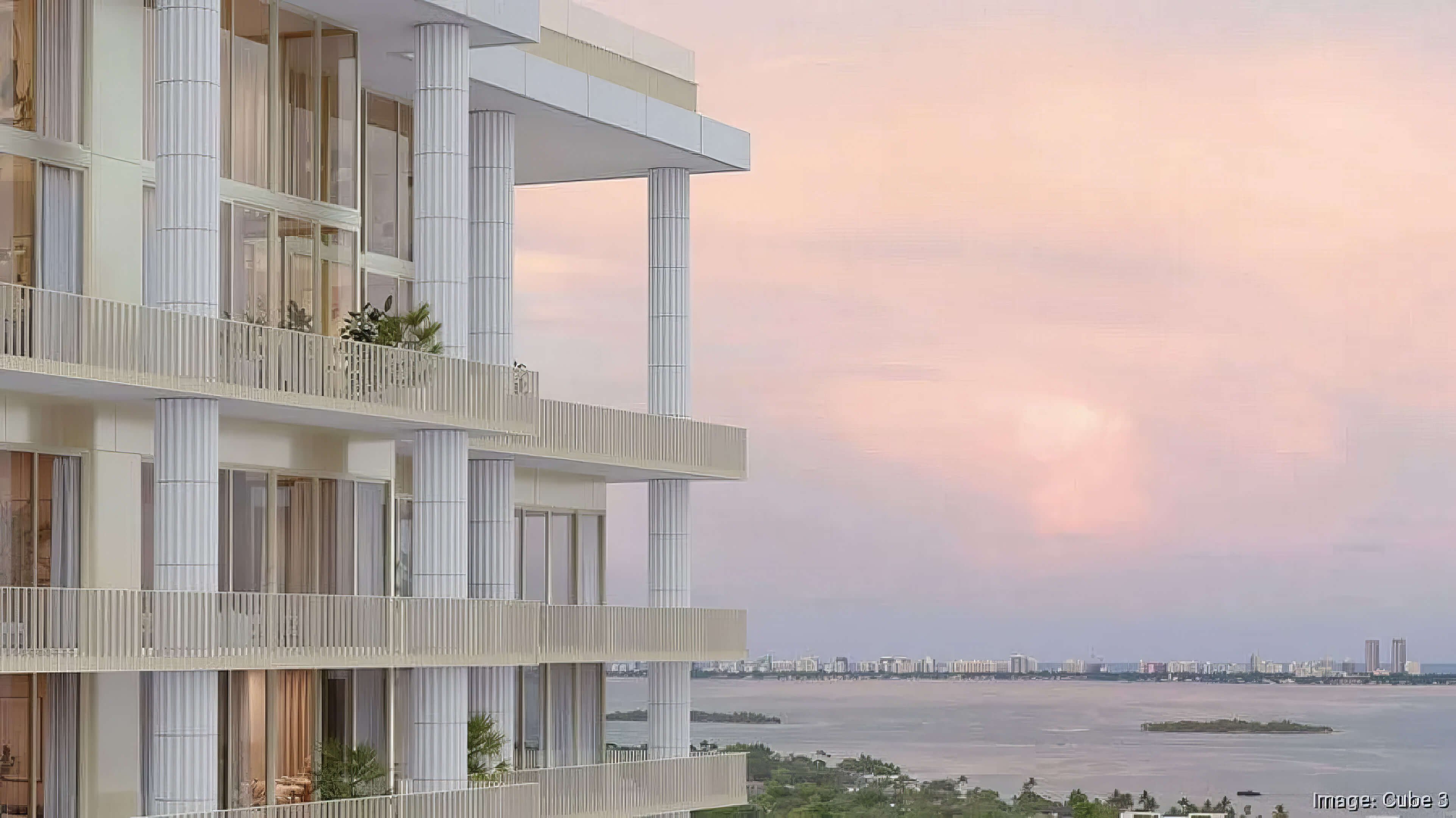 Balcony facade with slender columns overlooking the bay at sunset at Fouquet’s Hotel & Residences