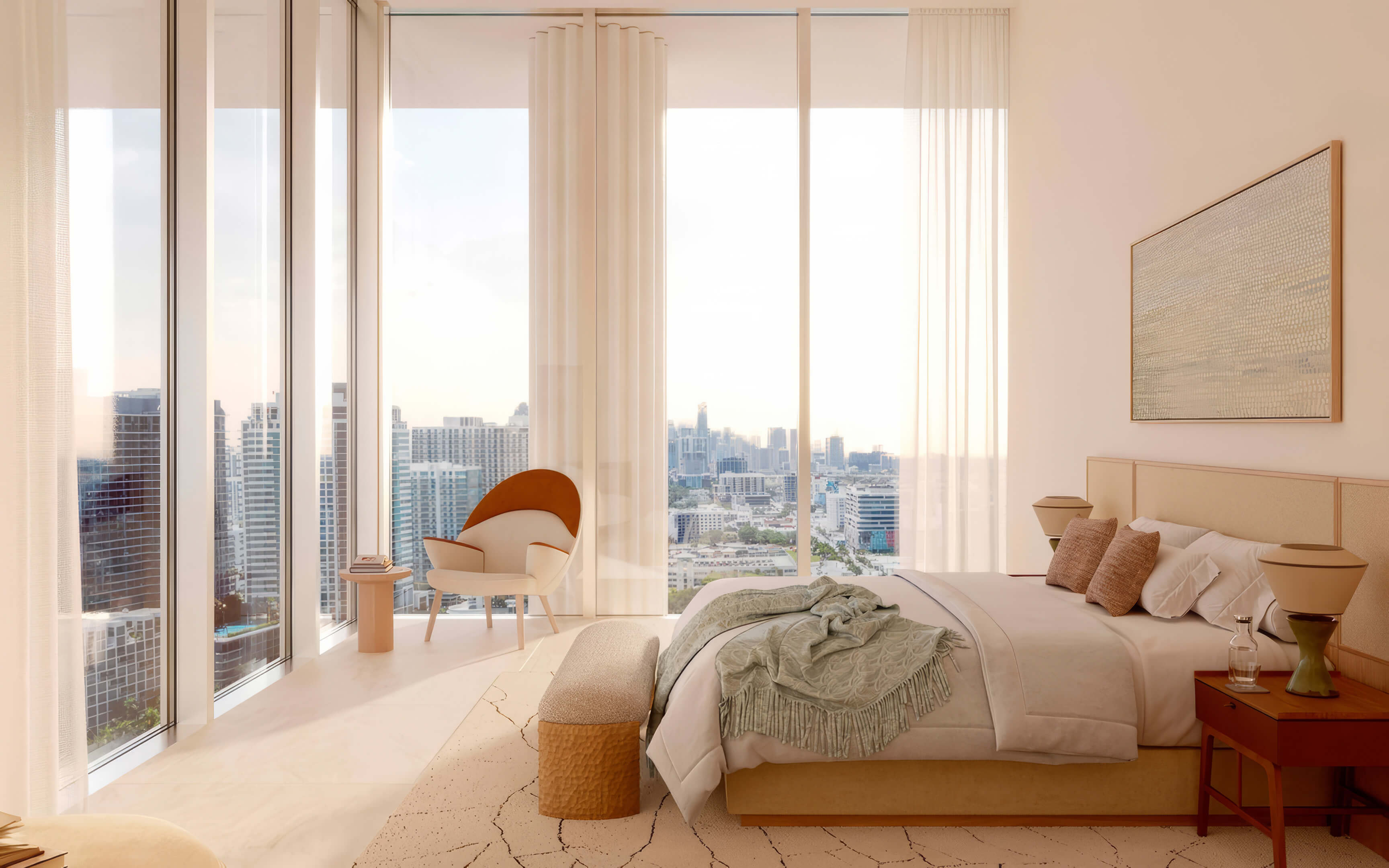 Bedroom with tall corner windows, a lounge chair, and warm evening light at Fouquet’s Hotel & Residences