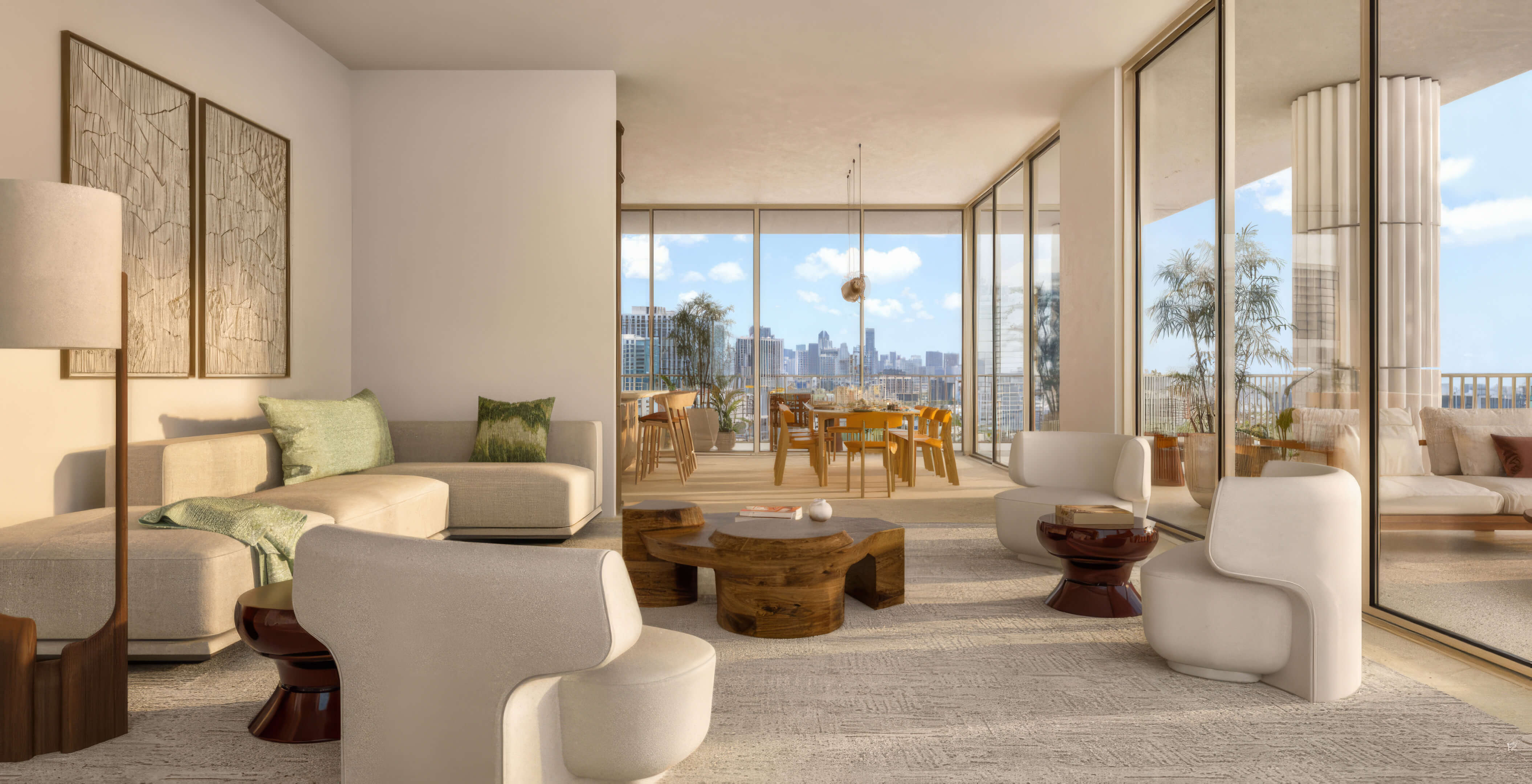 Corner living room with rounded chairs and a dining terrace beyond sliding glass doors at Fouquet’s Hotel & Residences