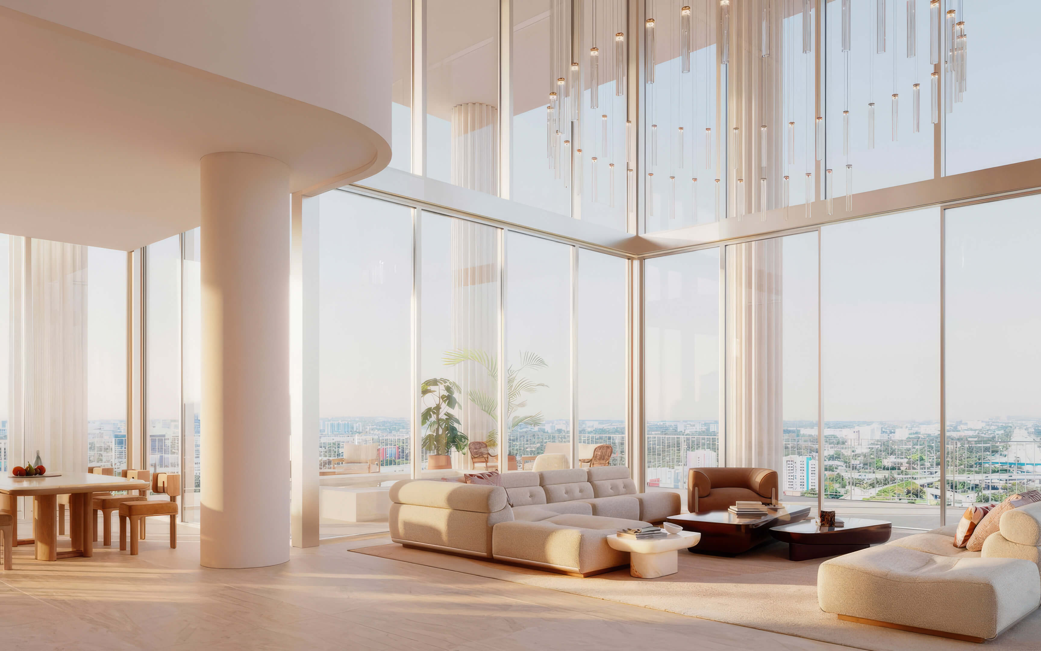 Double height living and dining room with curved sofas and expansive city views at Fouquet’s Hotel & Residences