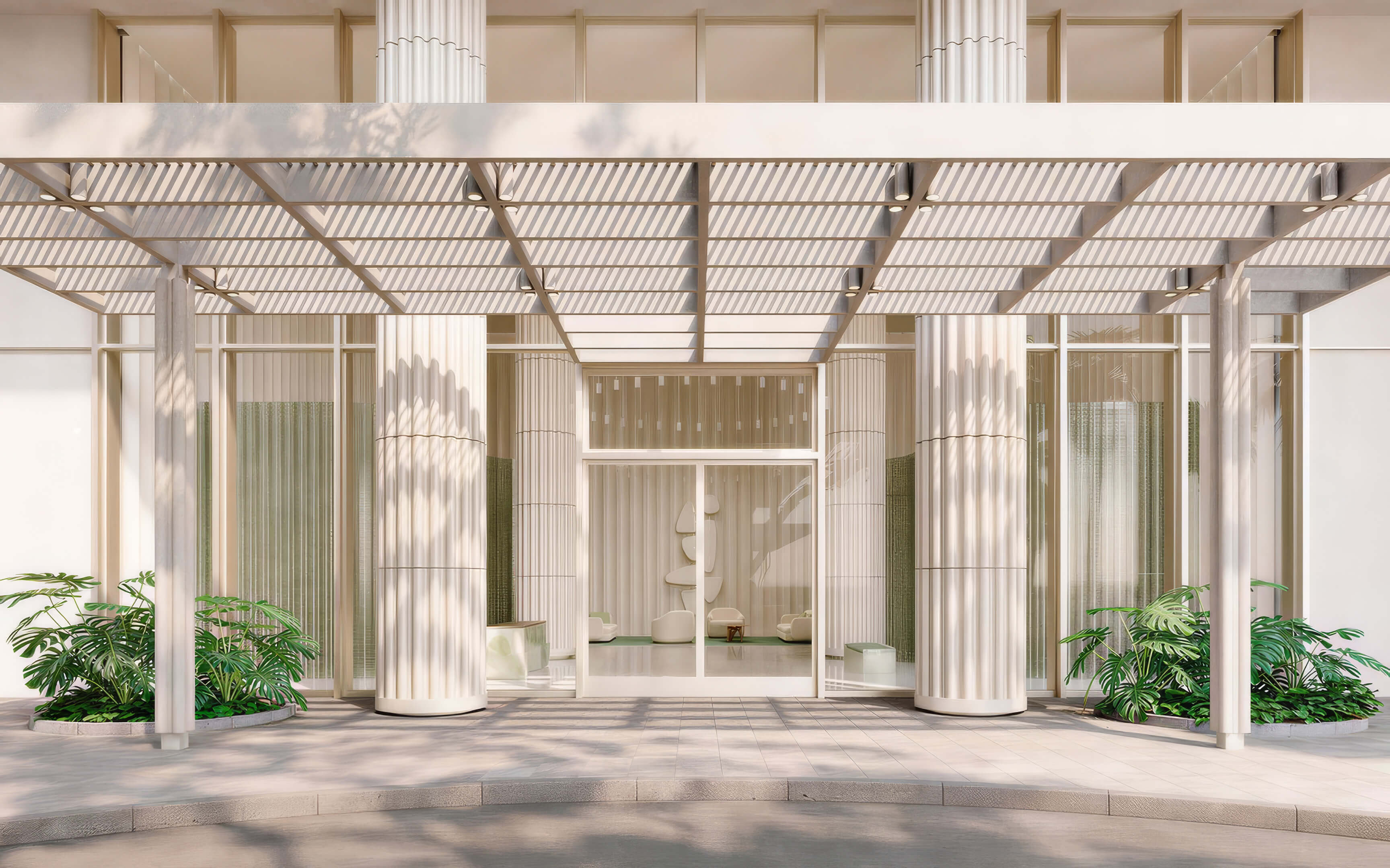 Main entrance with a slatted canopy, fluted columns, and glass doors at Fouquet’s Hotel & Residences