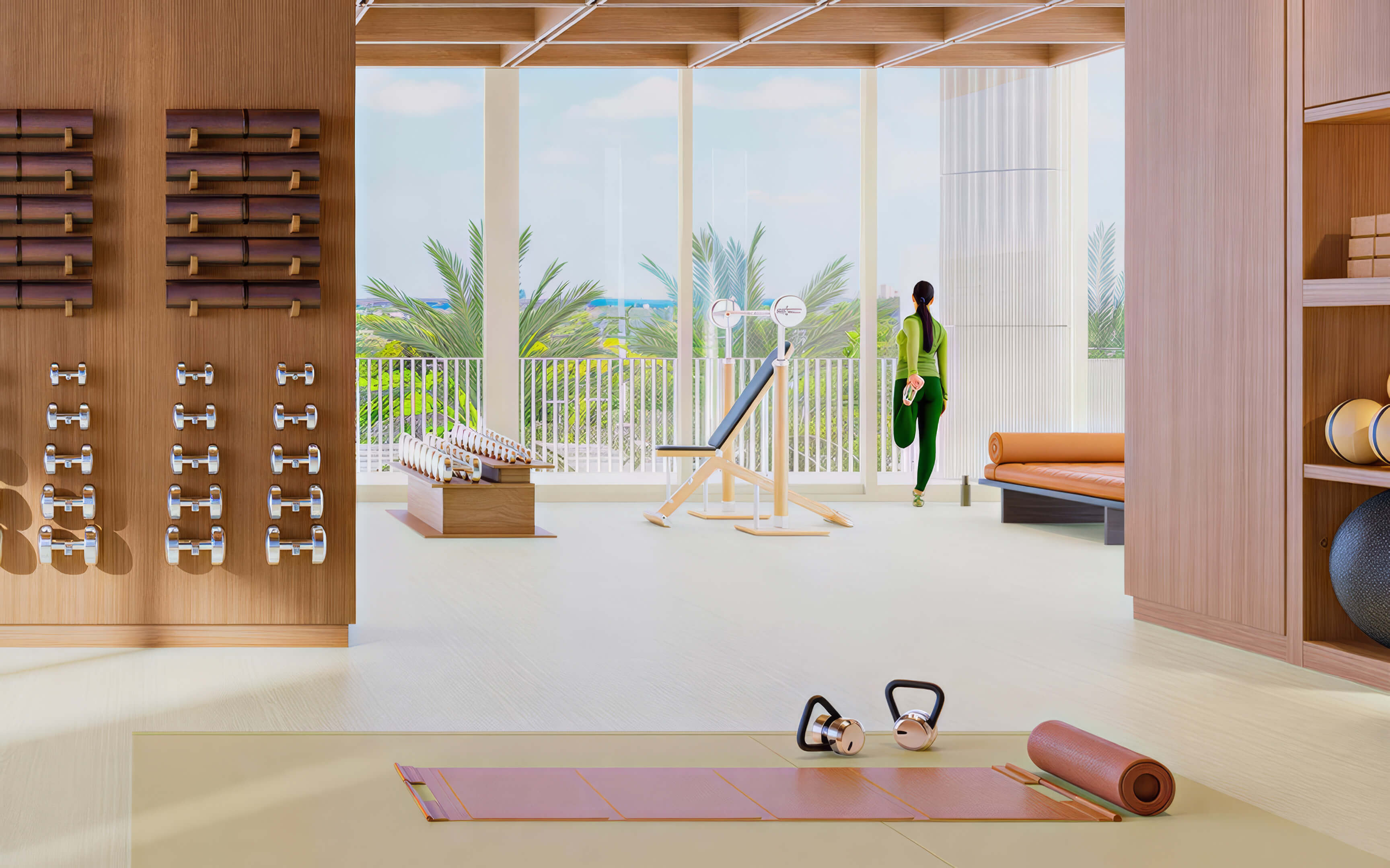 Fitness studio with yoga mats, kettlebells, wall-mounted weights, and an exercise bench at Fouquet’s Hotel & Residences