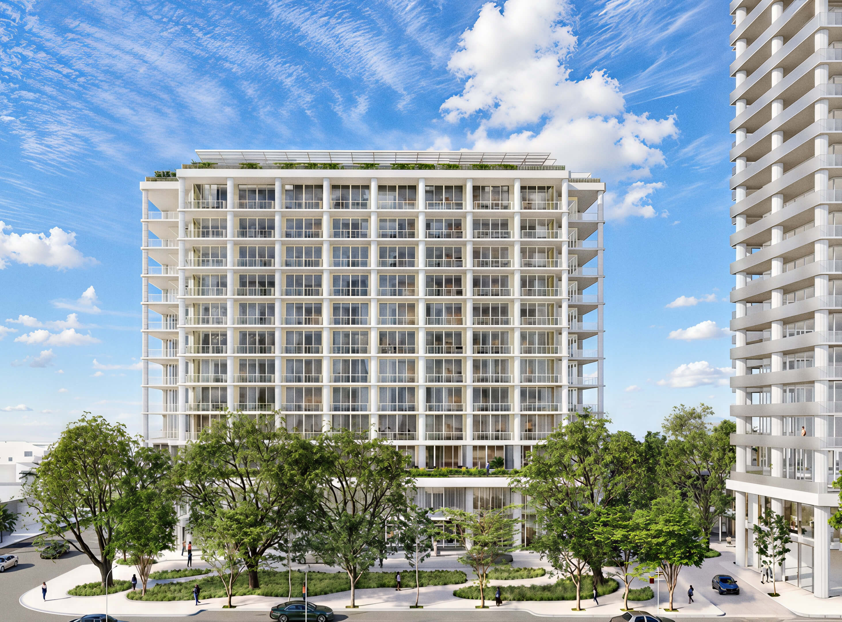 Broad building facade with stacked balconies above a tree-lined street at Fouquet’s Hotel & Residences
