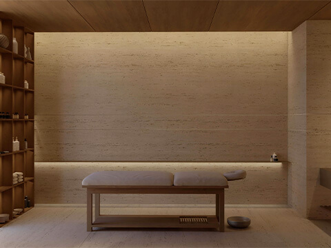 Massage treatment room at HQ Residences Miami with spa table, stone walls and serene finishes