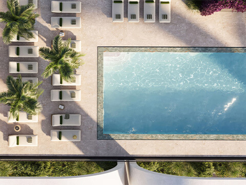 Aerial rooftop pool view at House of Wellness Brickell showing cabanas, sunbeds, landscaping, and resort-style deck layout