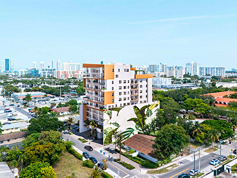 Aerial skyline view of LEV Residences Aventura Miami with the tower rising above lush surroundings and city buildings
