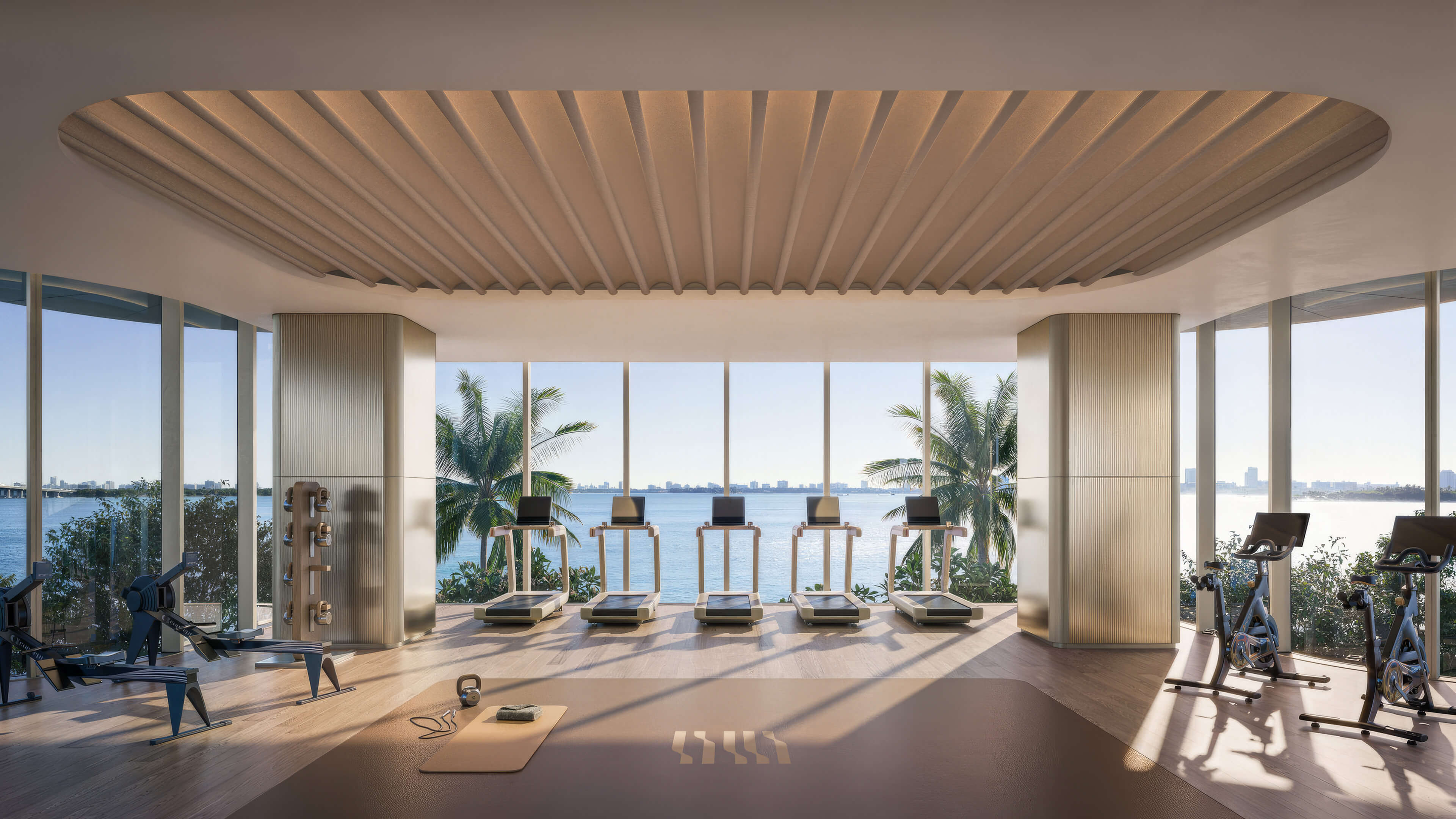 Fitness center at Lilli Miami Edgewater with cardio equipment and waterfront bay views