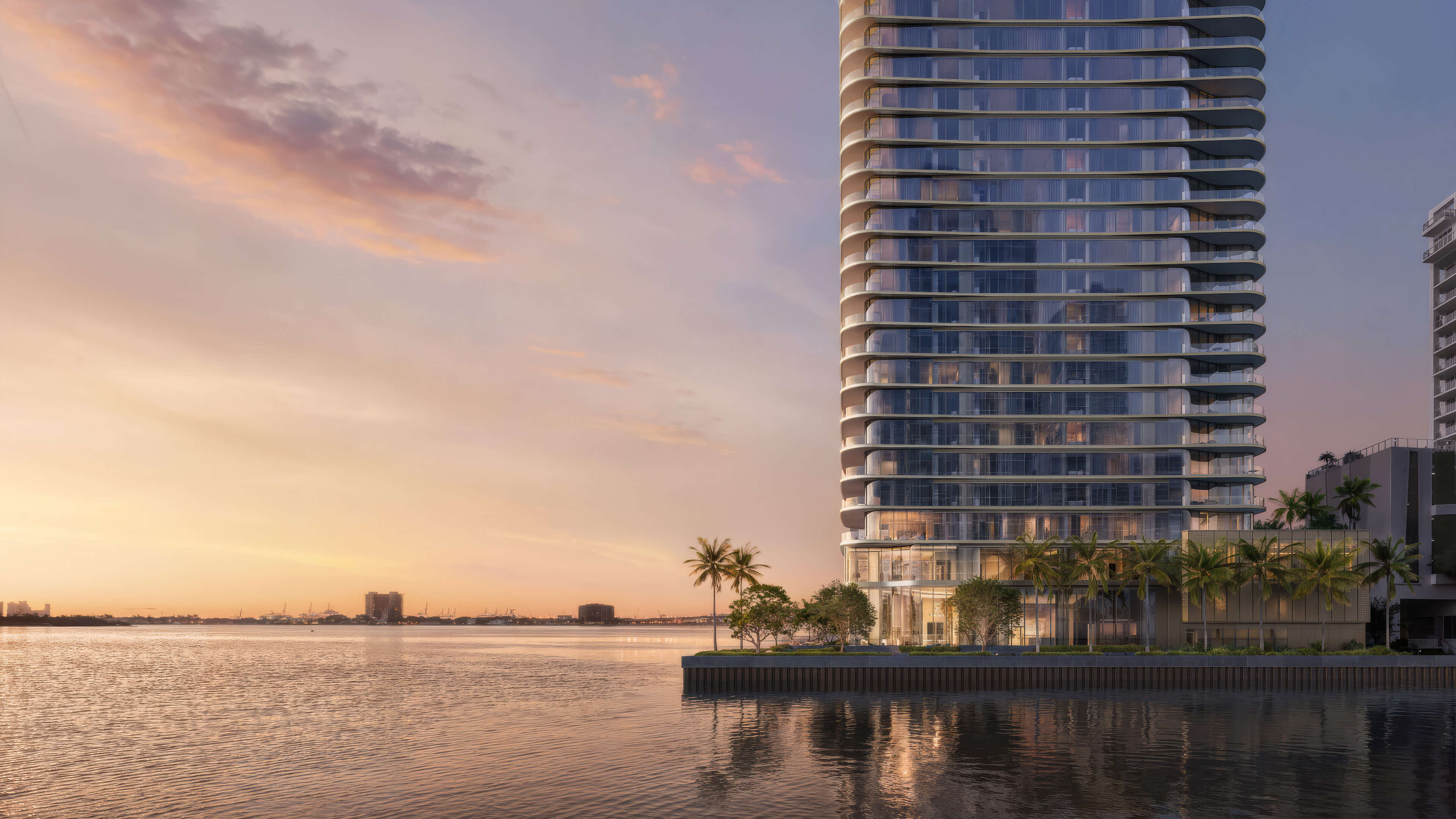 Luxury waterfront tower of Lilli Miami Edgewater at sunset with modern glass balconies