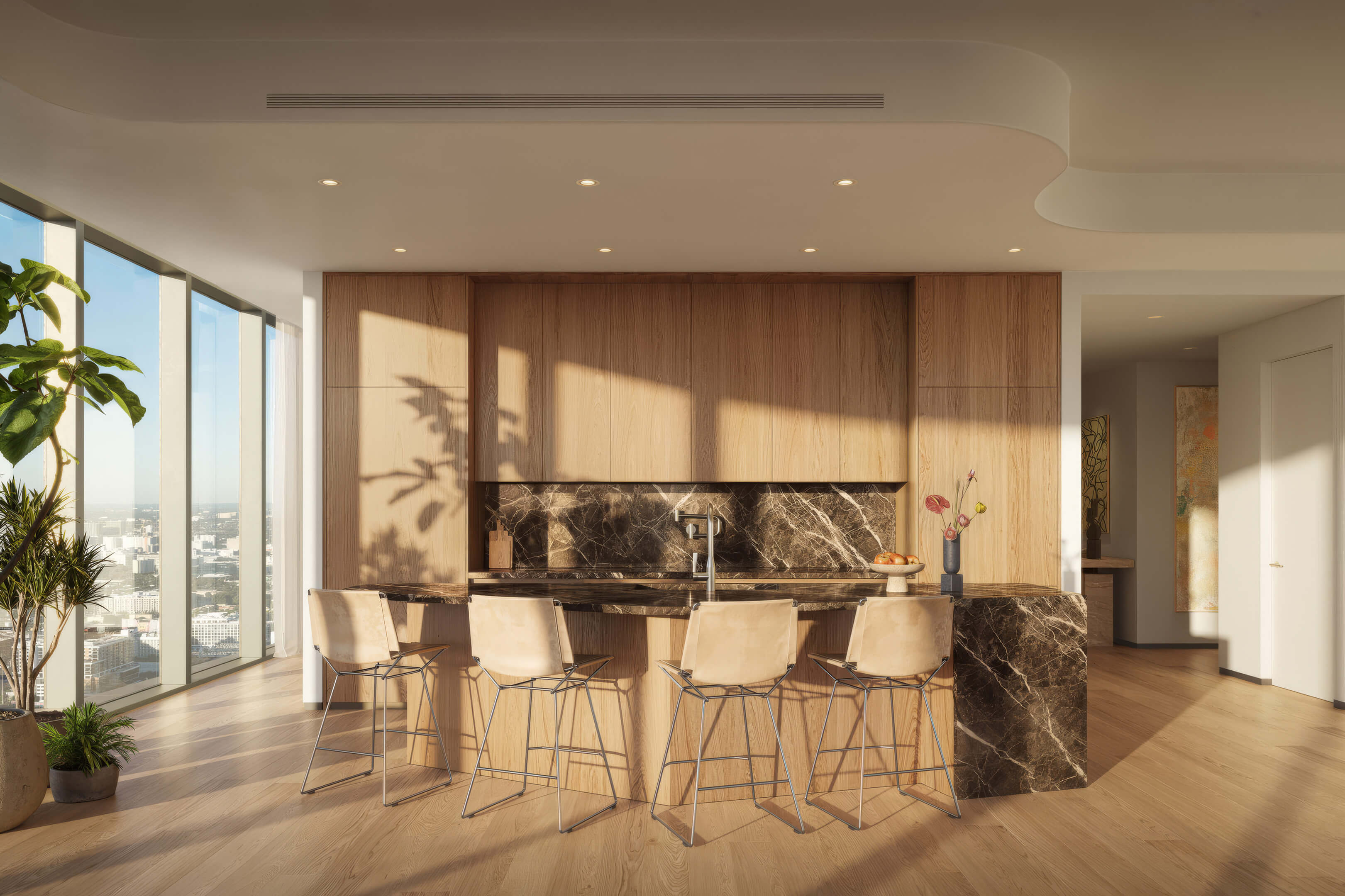 Modern kitchen interior at Lilli Miami Edgewater with wood cabinetry, marble island and city views