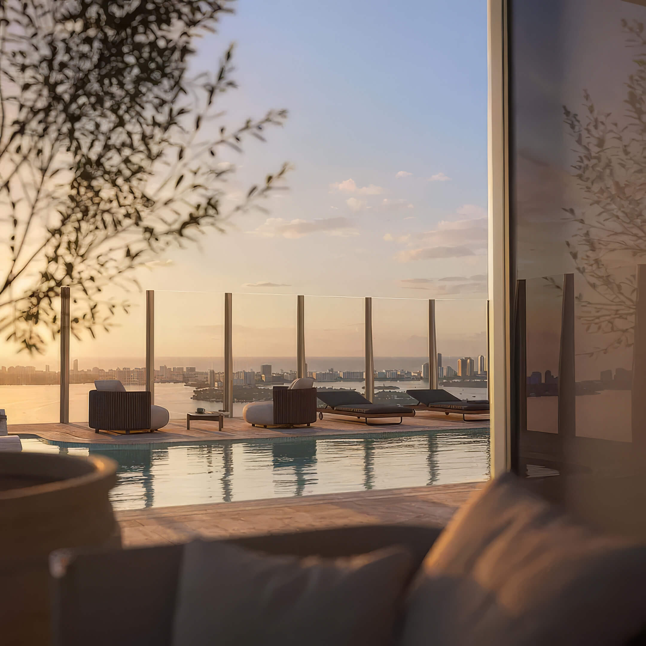 View from a shaded lounge at Lilli Miami Edgewater toward the rooftop pool and sun loungers at sunset