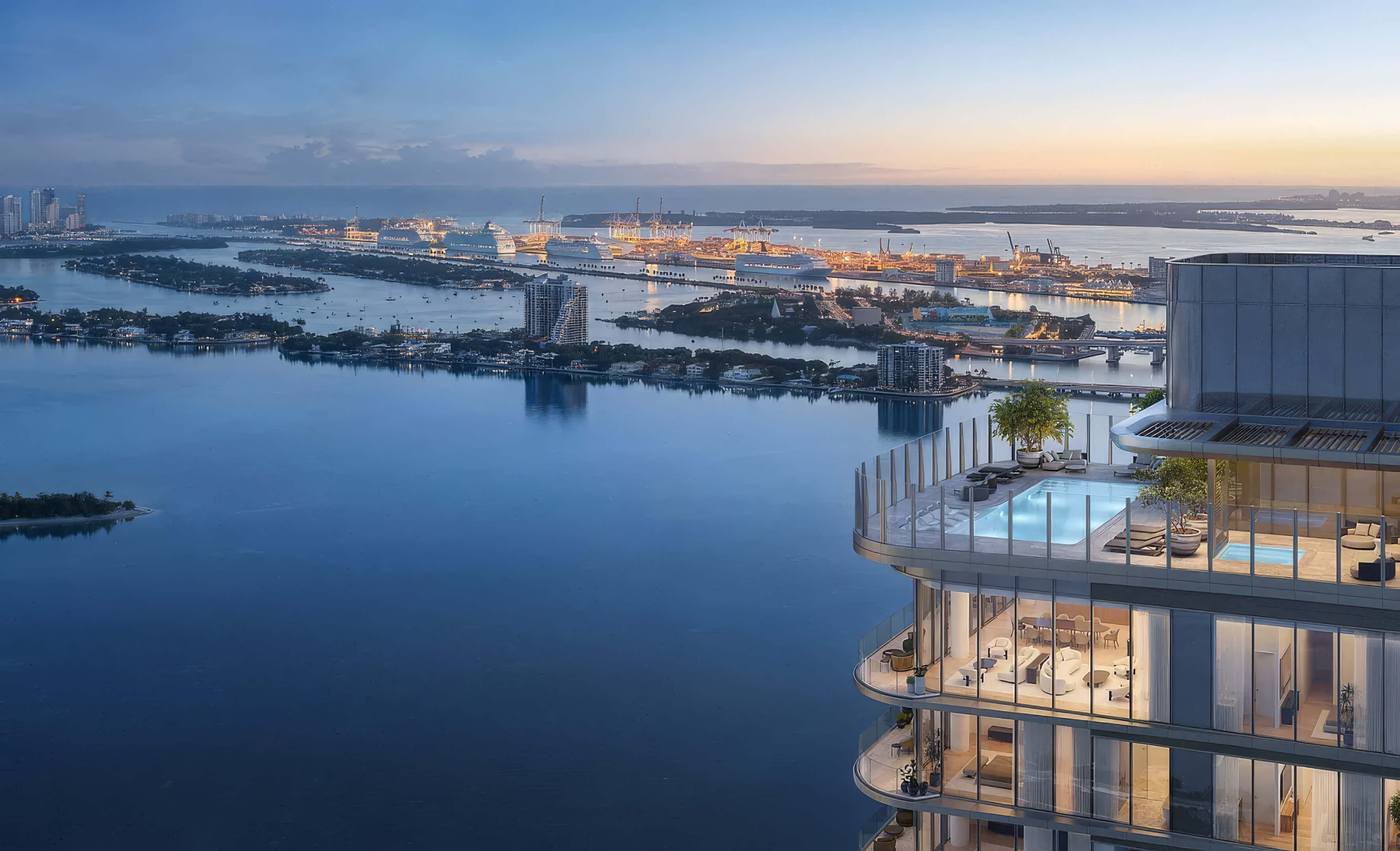 Elevated view of the rooftop pool at Lilli Miami Edgewater overlooking the bay and illuminated city at dusk