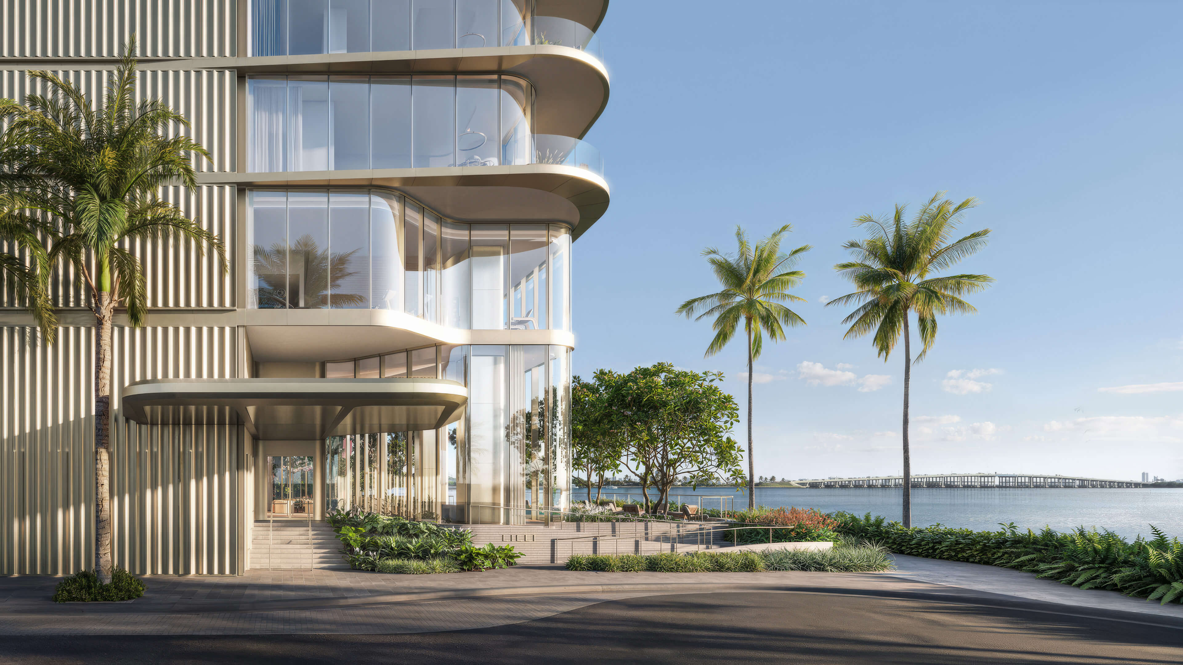 Waterfront entrance of Lilli Miami Edgewater with palm trees and contemporary residential design