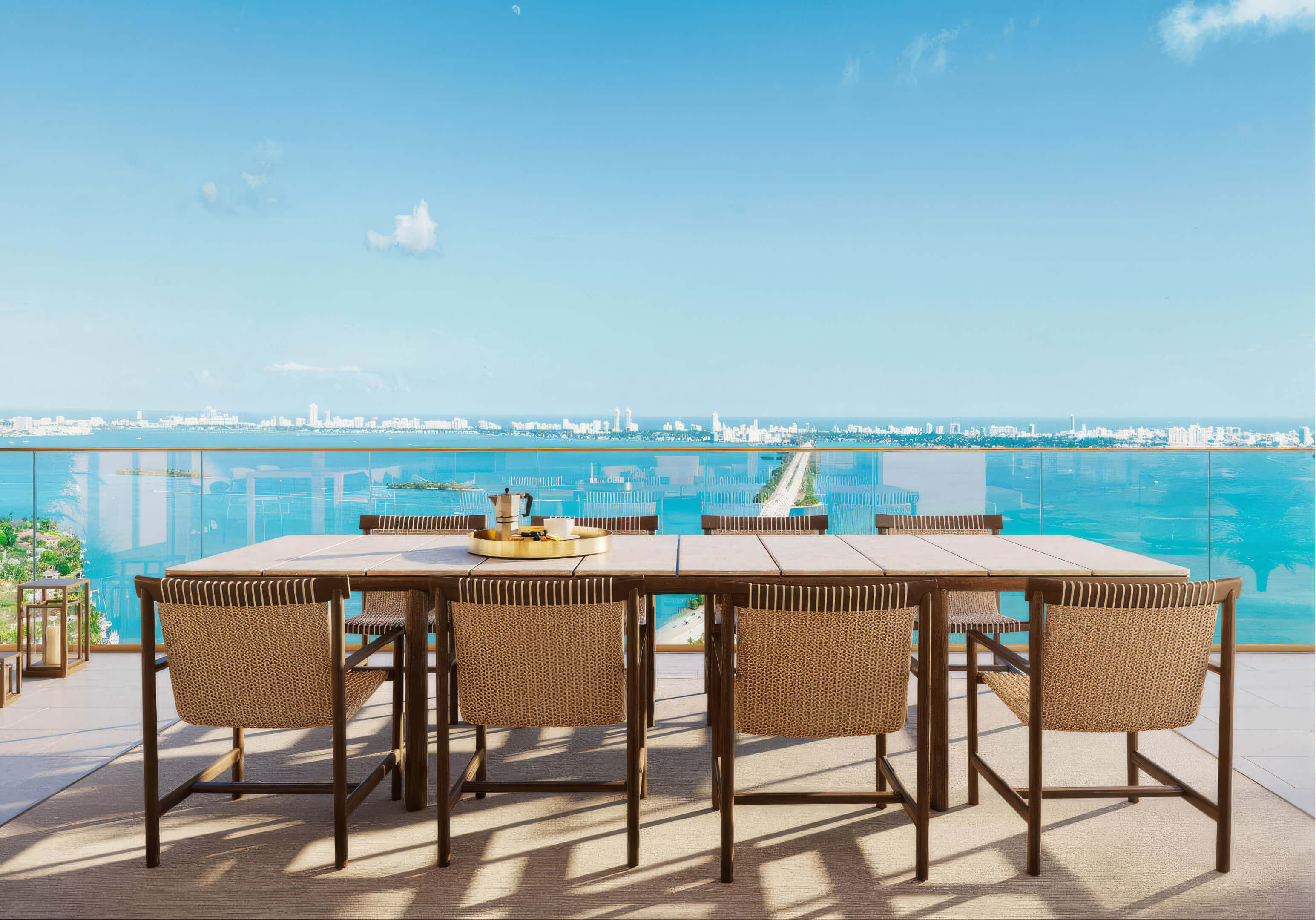 Outdoor dining on the balcony with stunning Biscayne Bay views at Miami Tropic Residences