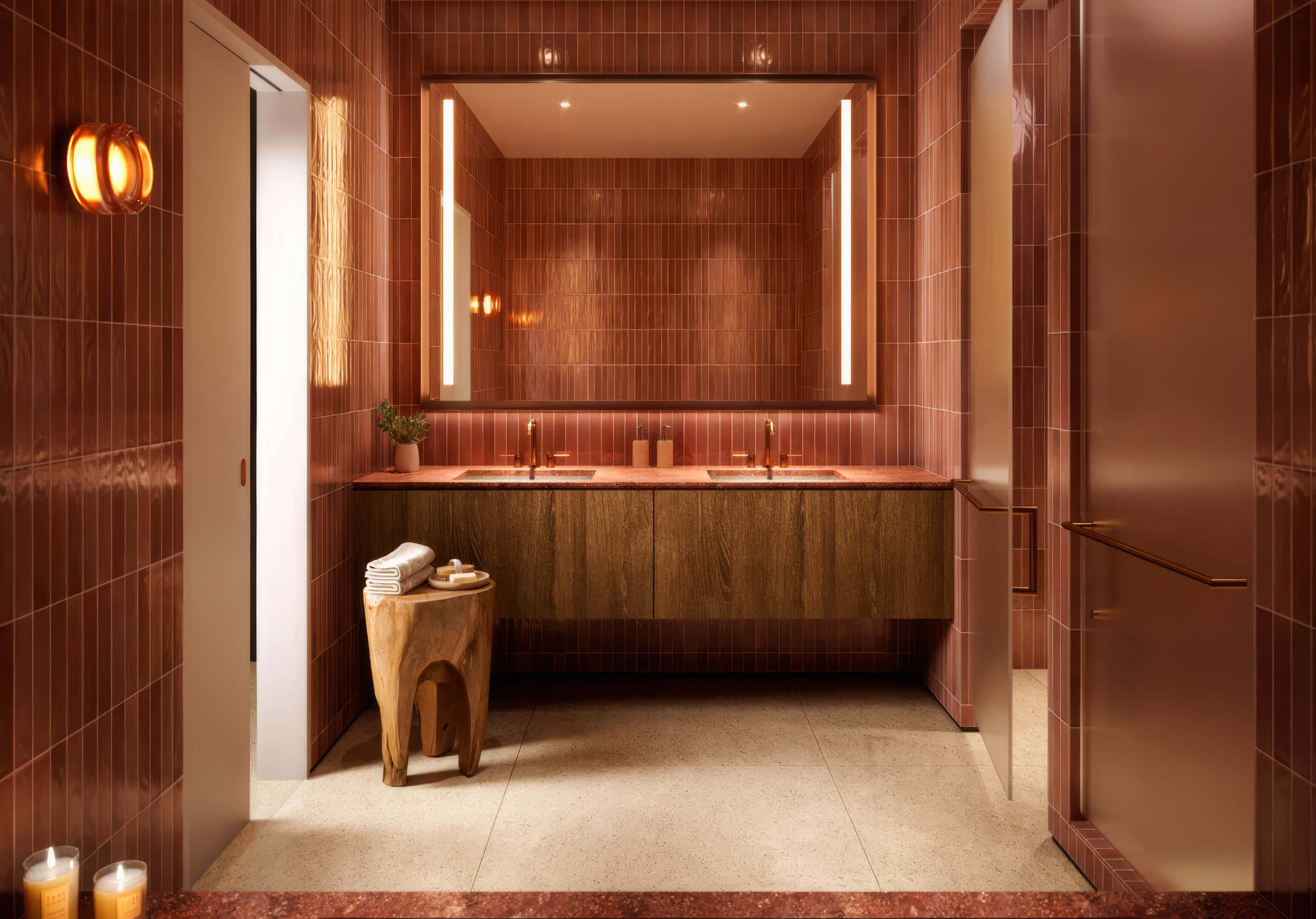Modern bathroom with double vanity and warm finishes at Miami Tropic Residences