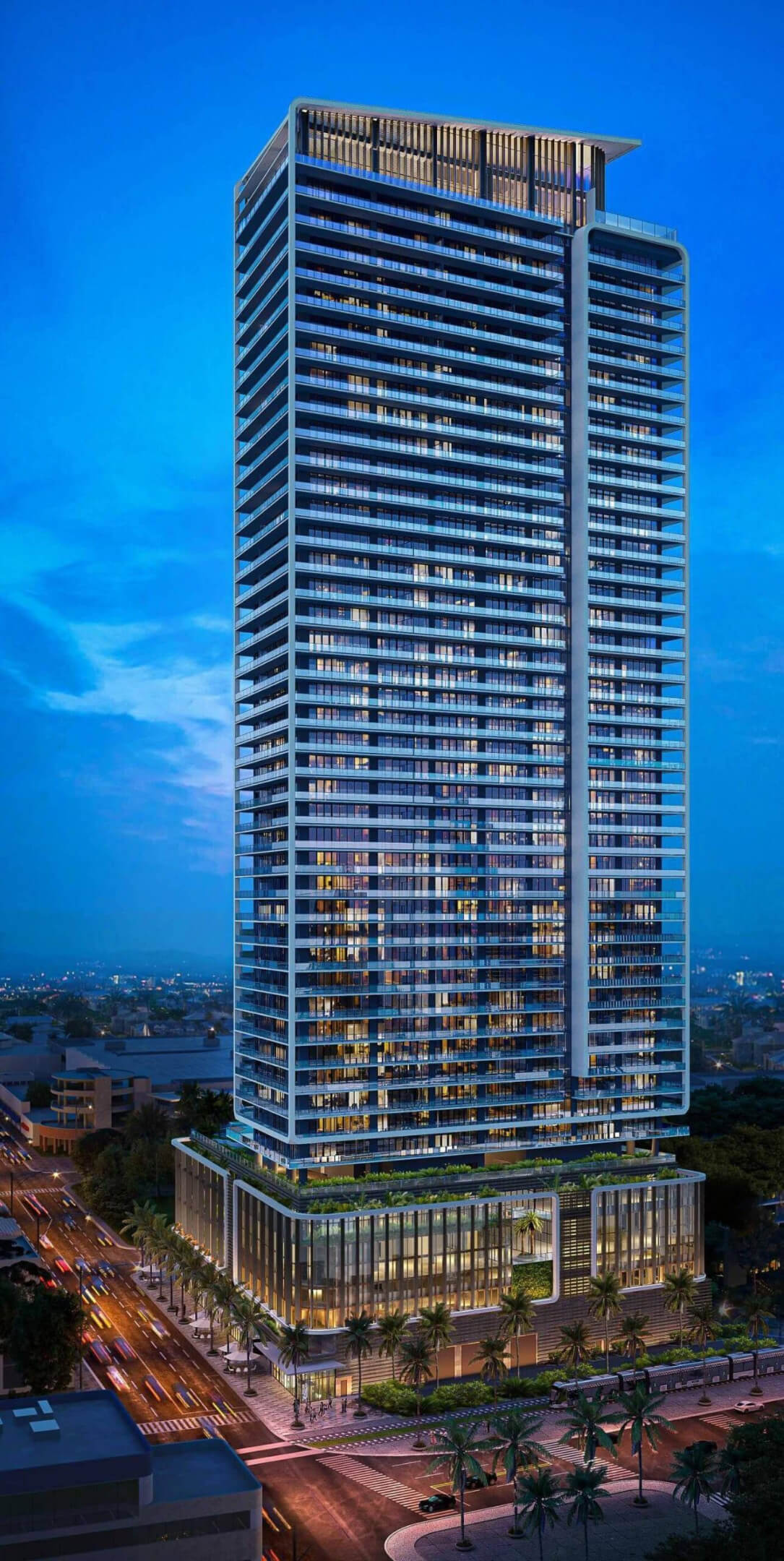 Miami Tropic Residences tower illuminated at night with cityscape views