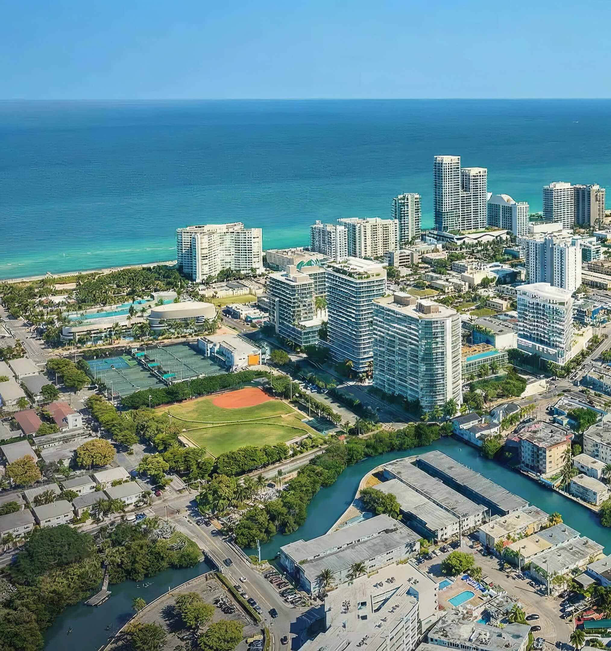 Coastal aerial view of NoBe Parc Miami Beach surrounded by ocean, parks, canals and nearby residential towers