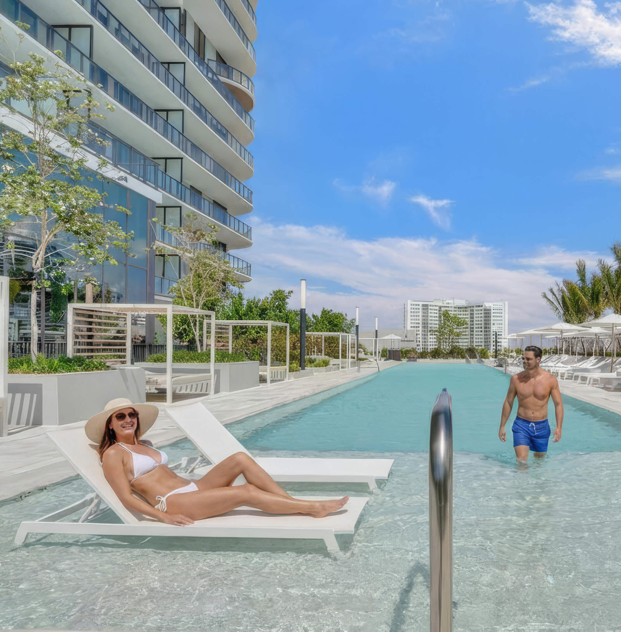Resort-style pool at NoBe Parc Miami Beach with sun loungers, glass balconies and luxury outdoor relaxation areas