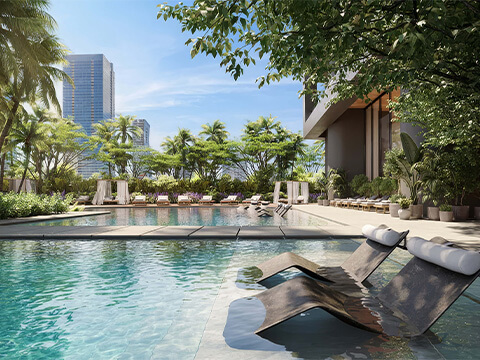 Resort-style pool deck at Ora by Casa Tua Miami with in-water loungers and tropical landscaping