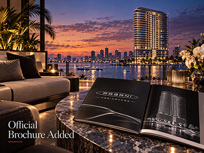 Pagani Residences official brochure displayed beside the North Bay Village waterfront tower at sunset