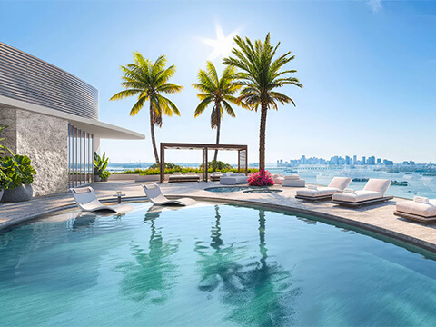 Rooftop pool sundeck at Pagani Residences with panoramic bay views, palm trees, and luxury outdoor relaxation