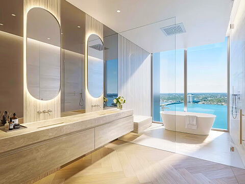 Spa bathroom at Pagani Residences with freestanding tub, illuminated mirrors, and panoramic bay views