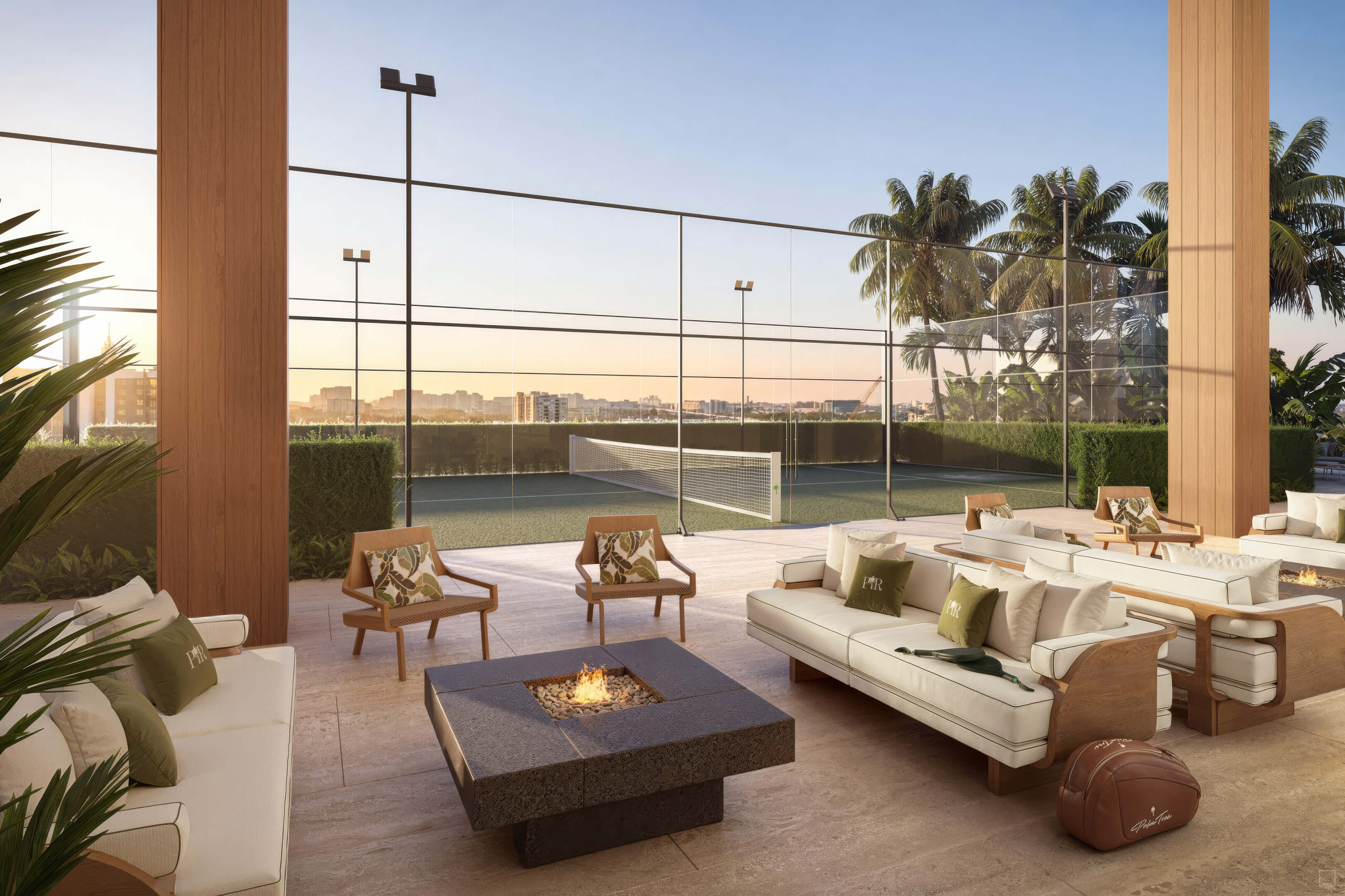 Outdoor lounge at Palm Tree Residences Miami with fire pit seating, tennis court and tropical palm trees