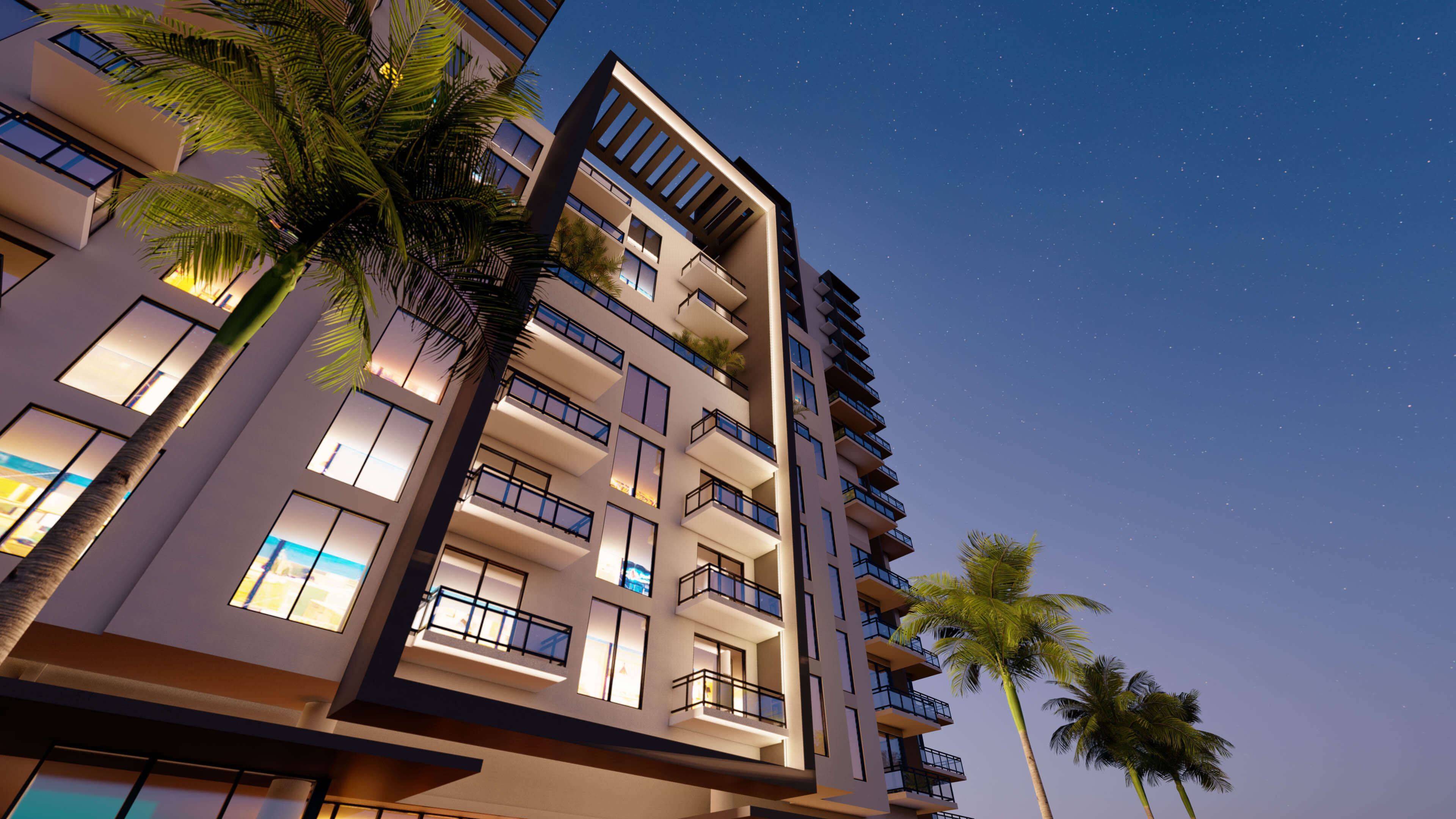 Night view of River District 14 with lit balconies and palm trees